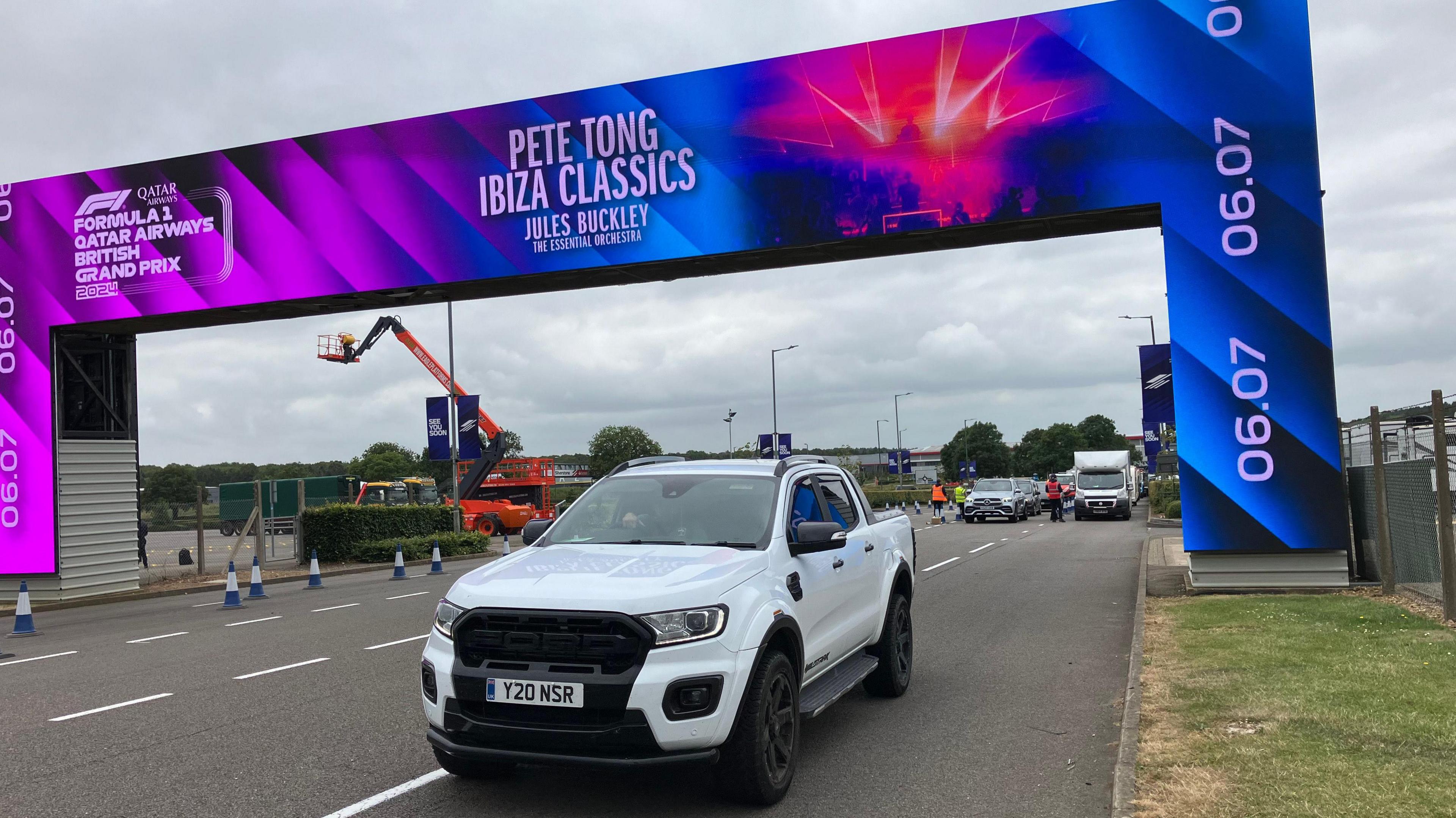 Entrance to Silverstone circuit with dynamic gantry advertising Pete Tong