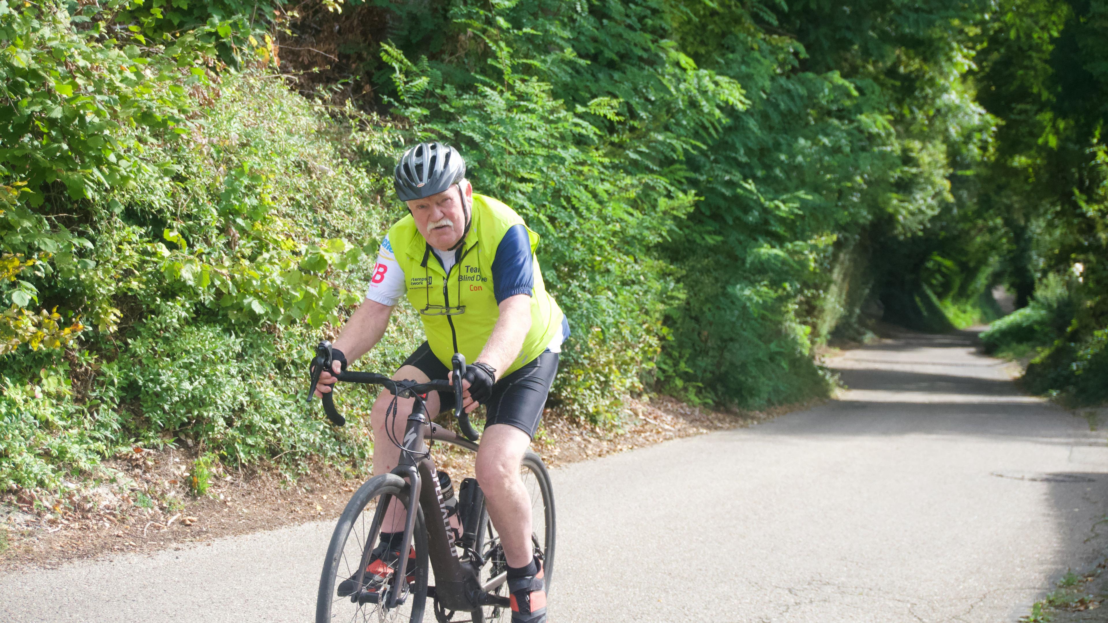 A man riding a bicycle on a road in France