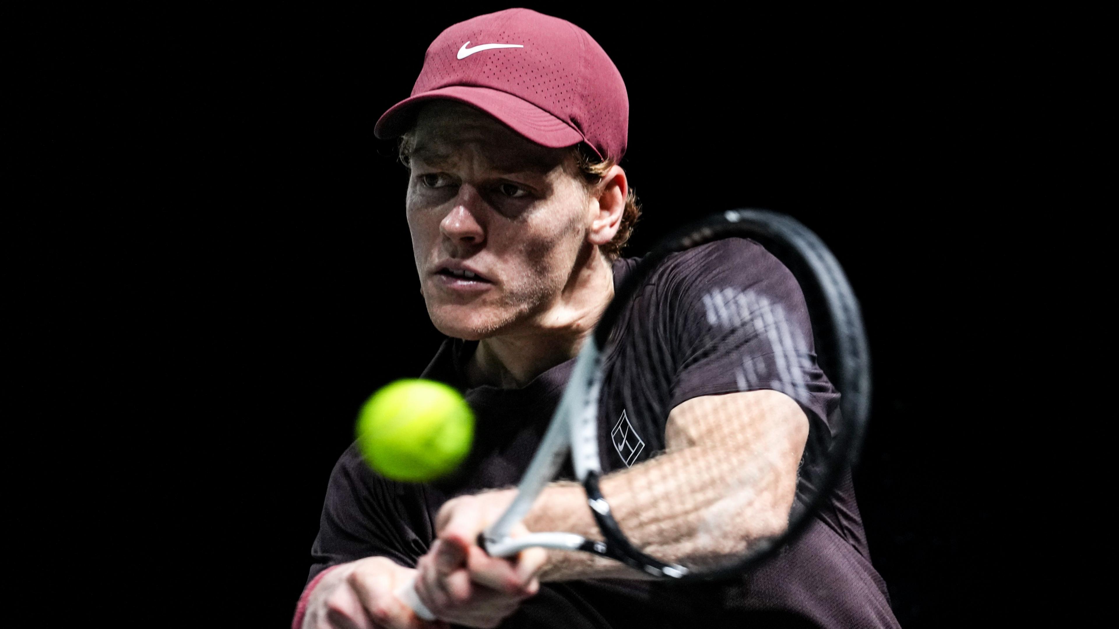 Jannik Sinner hits a backhand