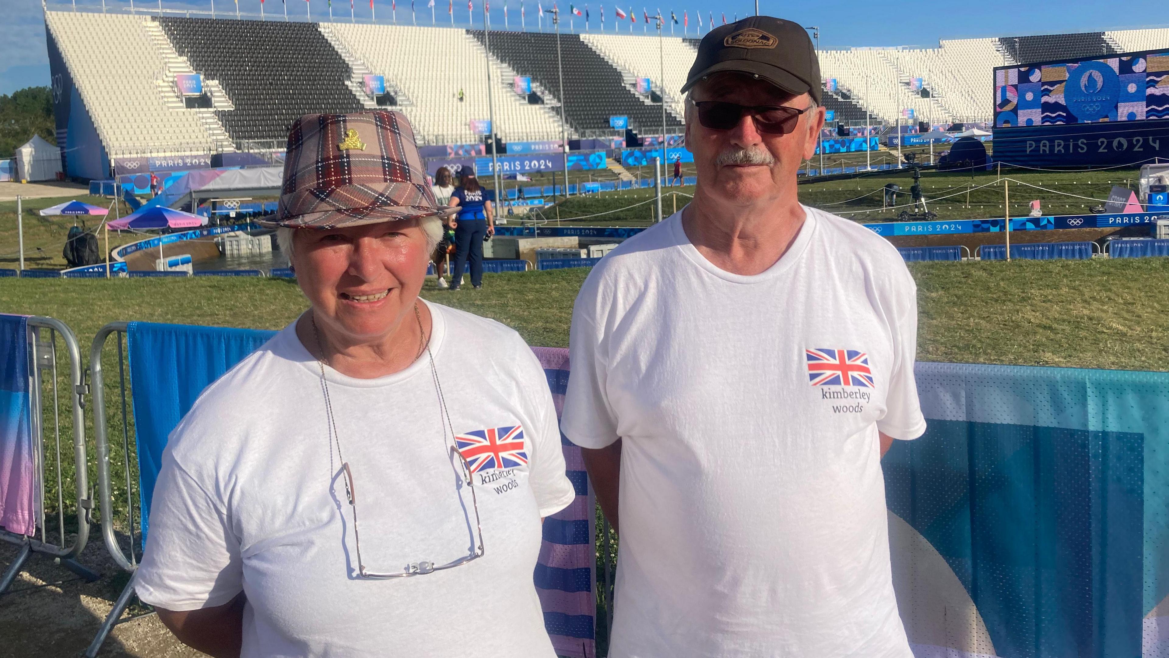 Kathleen and John Woods, they are both wearing hats and white t-shirts which have a Union Jack and "Kimberley Woods" written beneath it