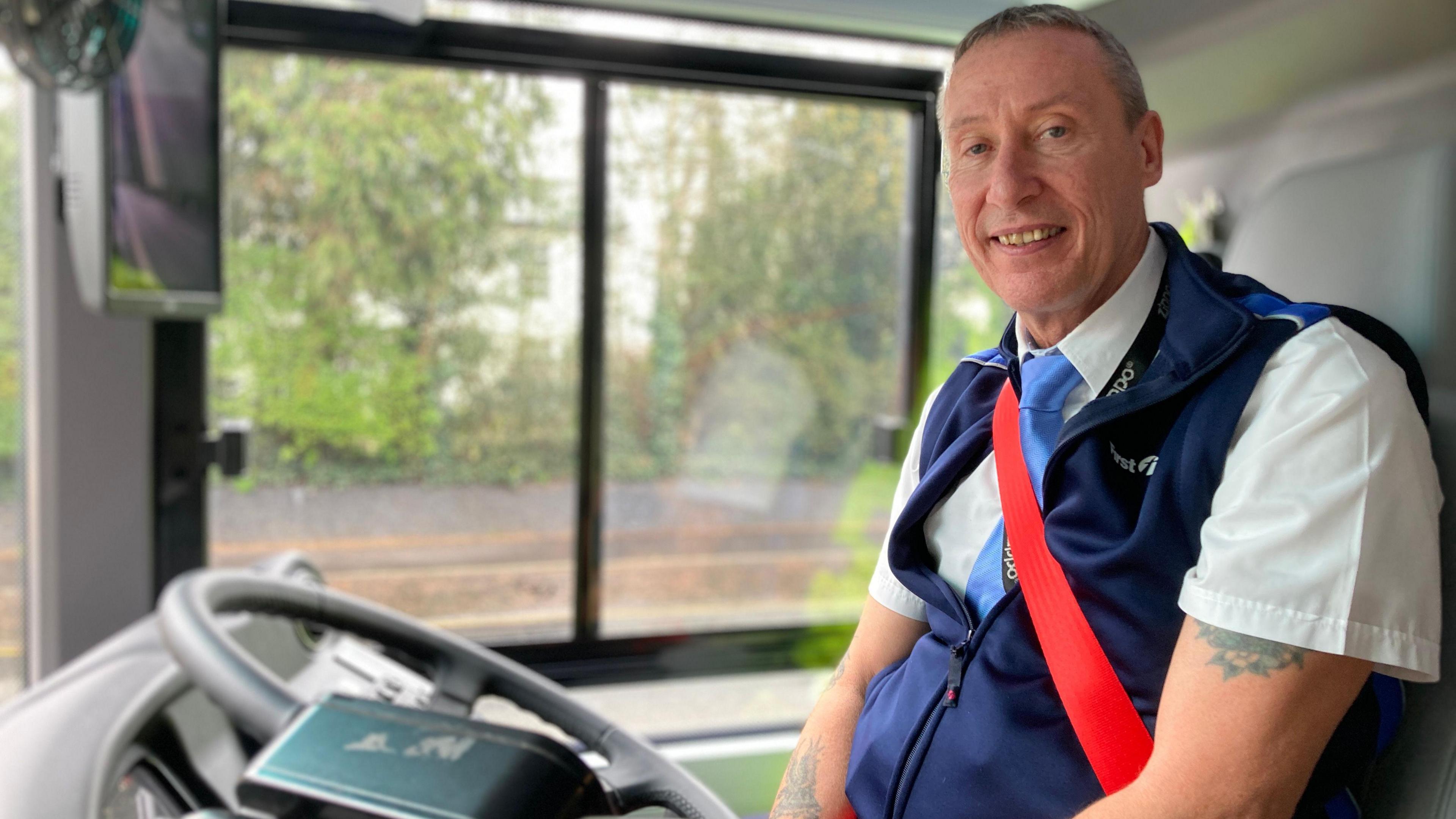 Bus driver Gordon Lowe sat in the drivers seat of his bus