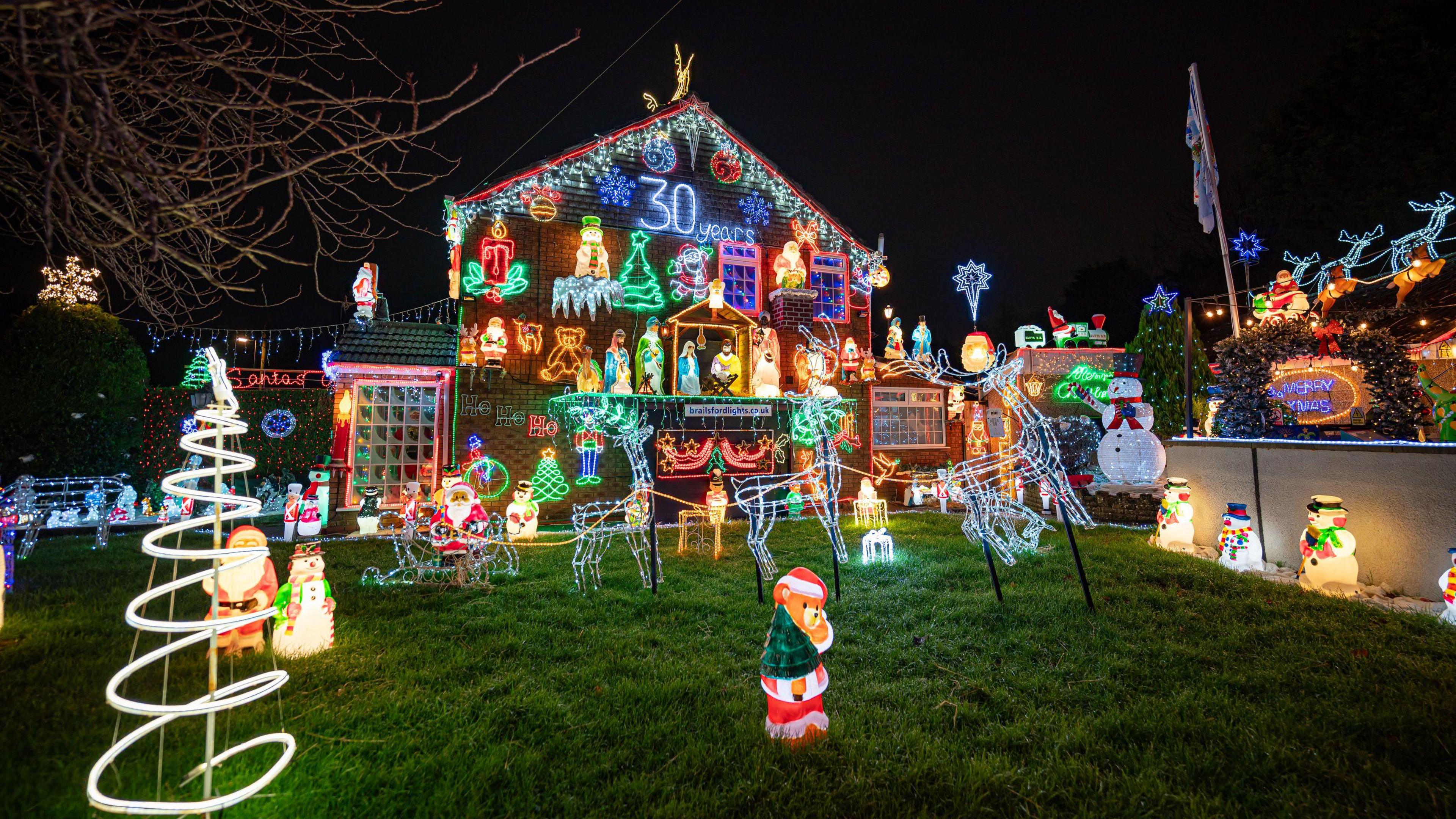 A house in Brentry, Bristol, which is covered in Christmas Lights. Lights spell out the word "Wonderland" at the top, and reindeer light figures can be seen on the rooftop. There are snowmen, Santa, stars and snowflake lights all over the house. They are all different colours. 