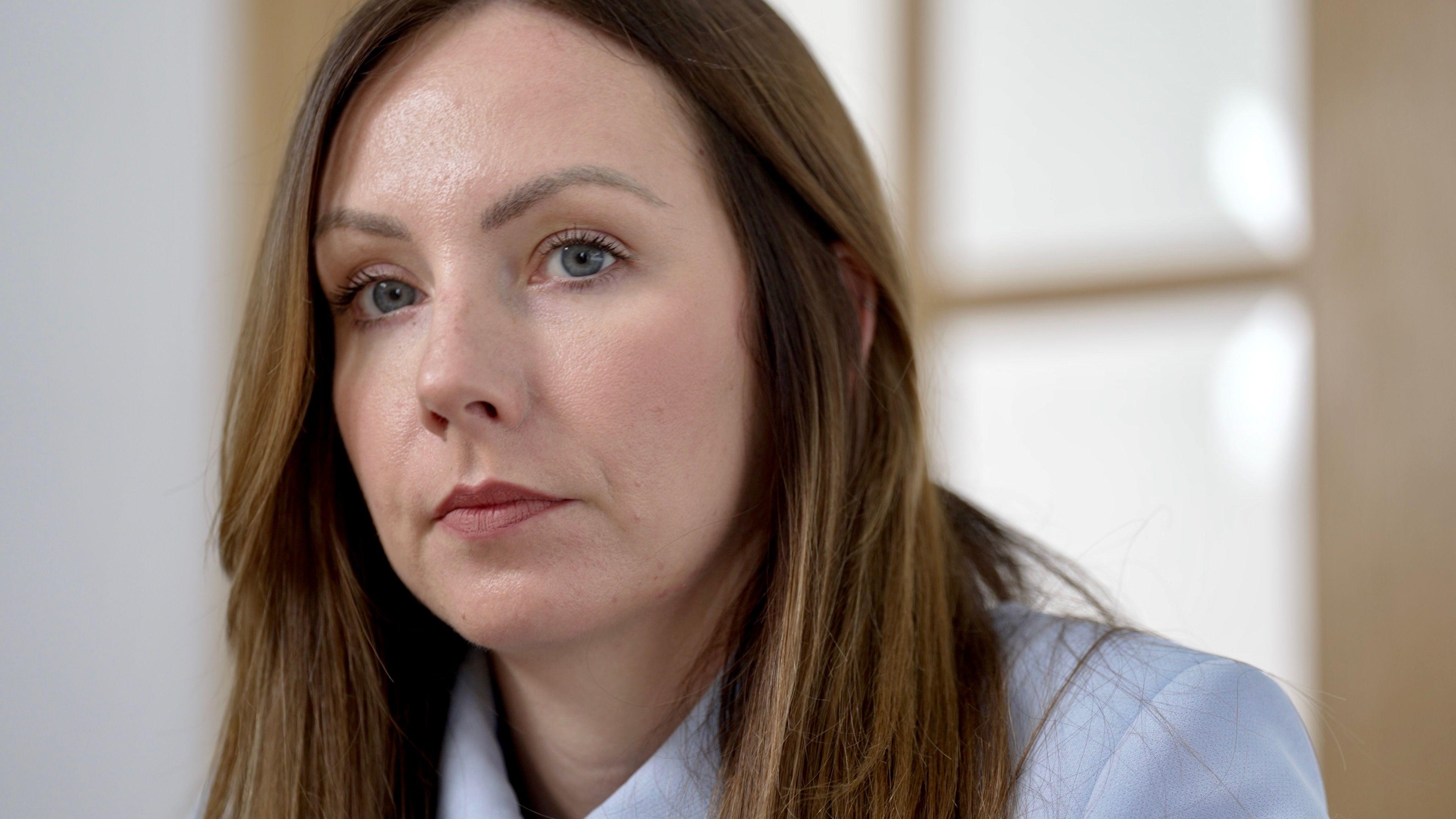 Headshot of Amy Clowrey. She has long, straight, light-brown hair and blue eyes and is wearing a blue jacket.