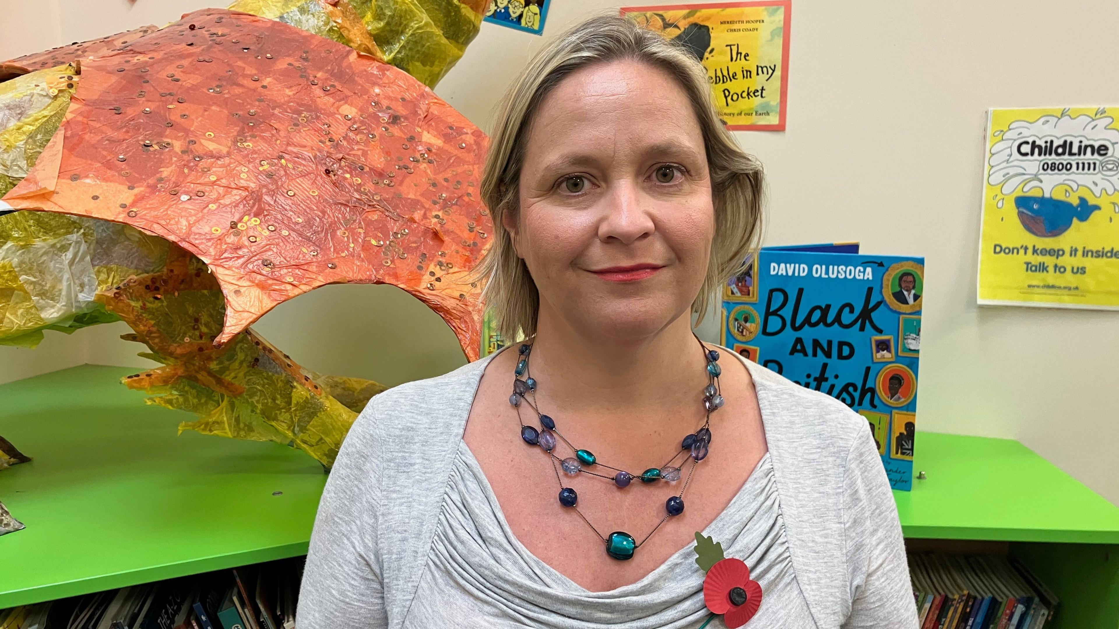 Dr Rachel Hayes from the University of Exeter standing in the Willand School Library