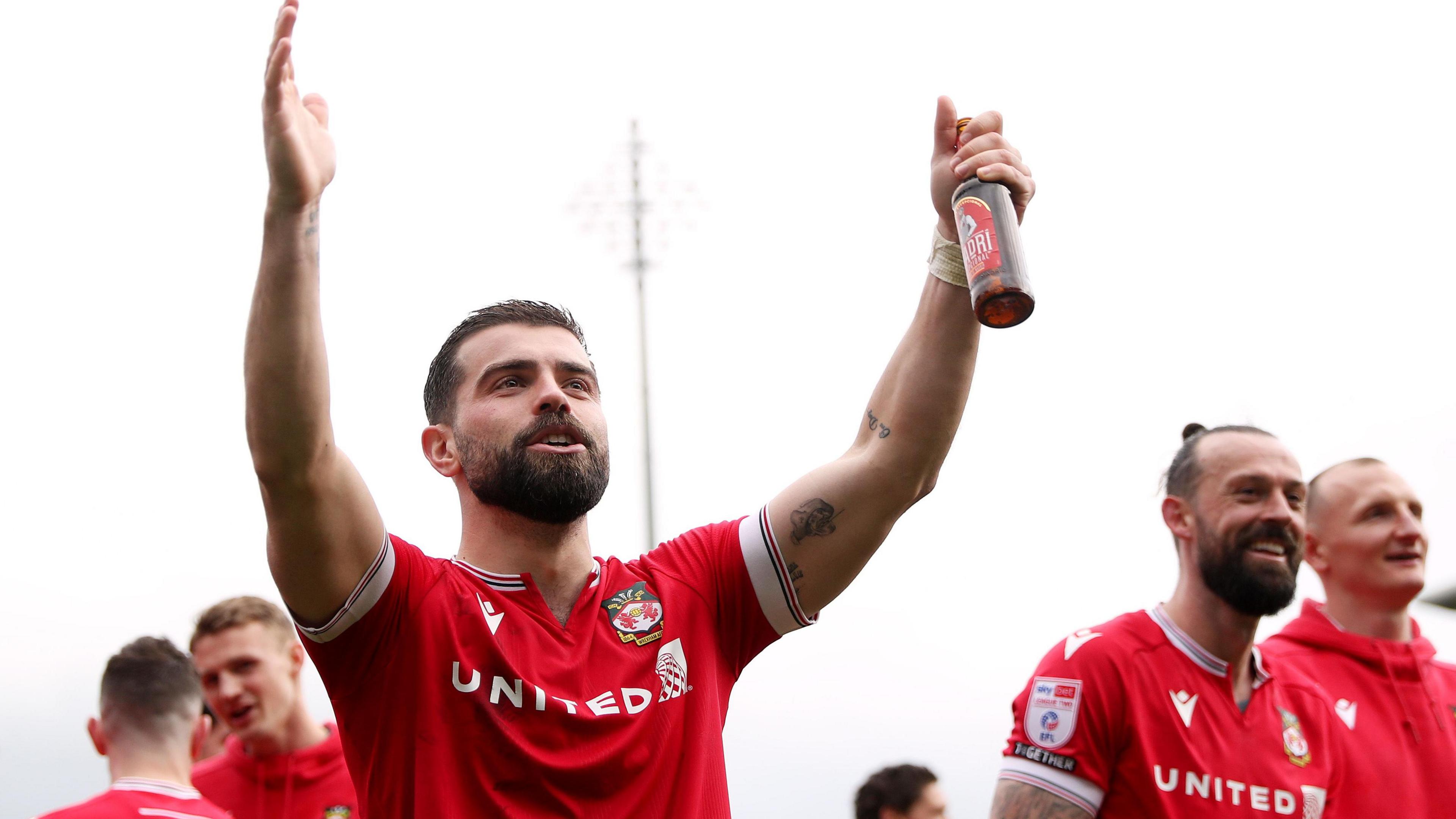 Elliot Lee celebrates after Wrexham secured automatic promotion last season