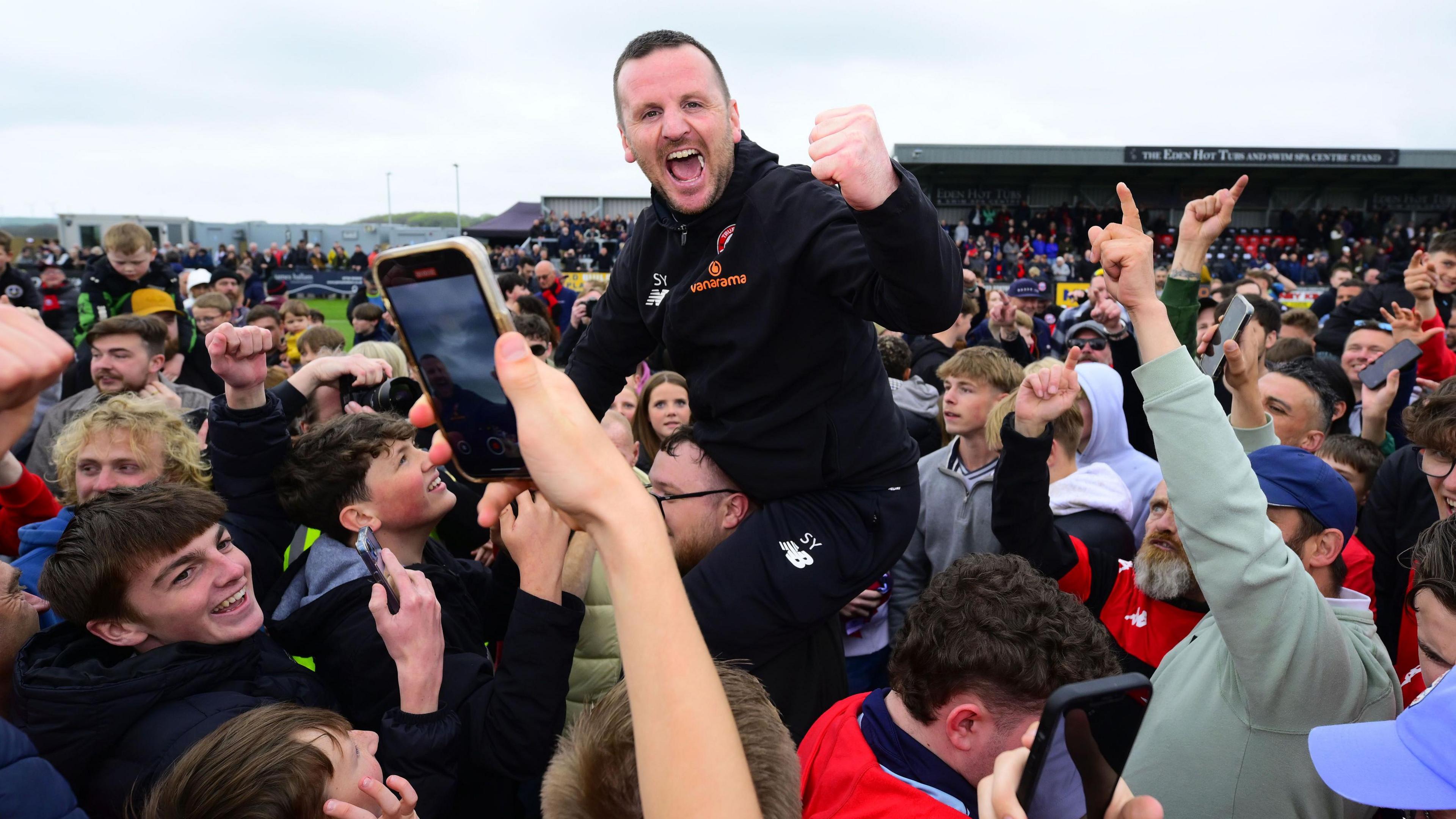 Stewart Yetton celebrates with the fans after winning the National League South title