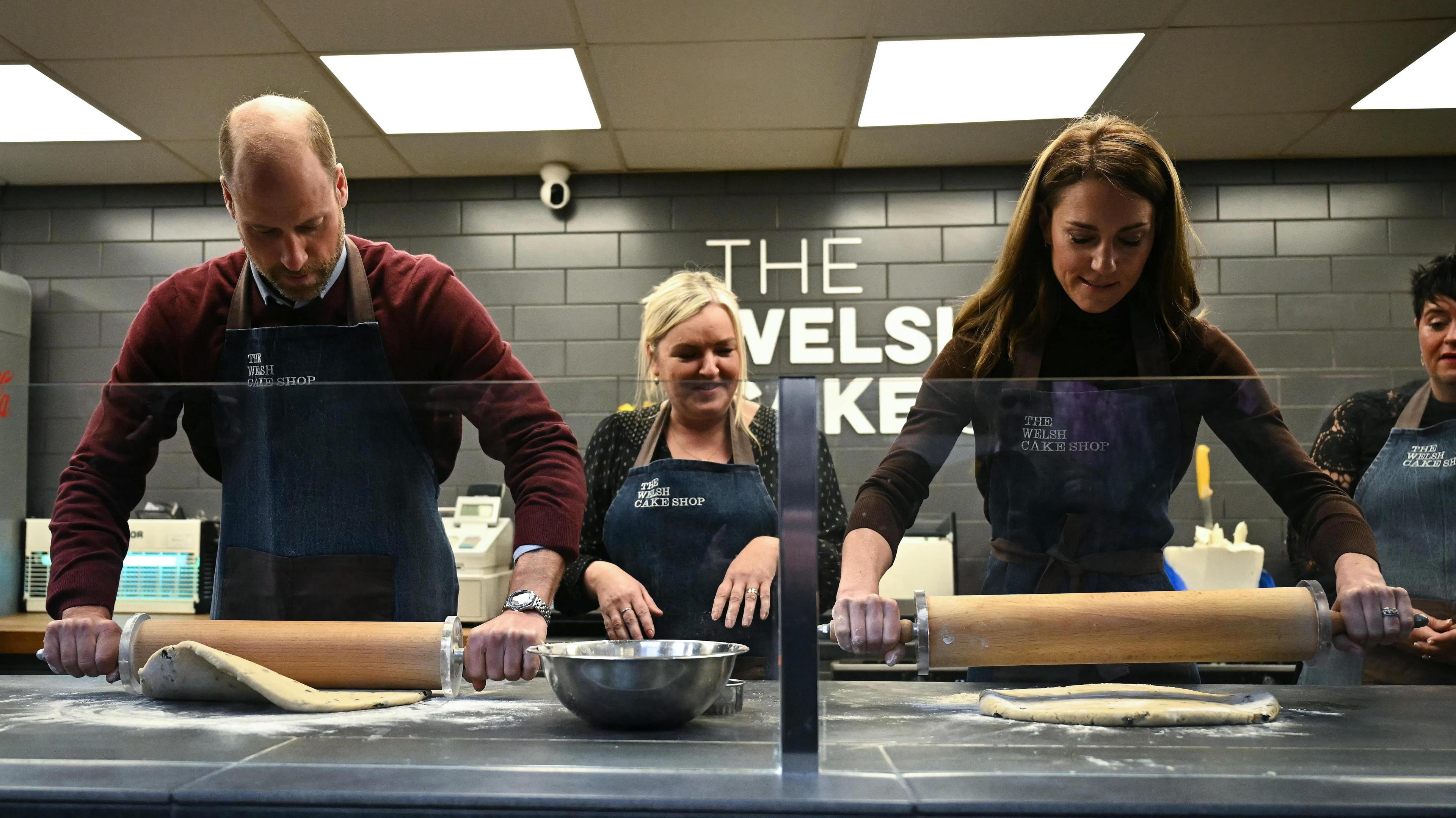 The Prince and Princess (second right) of Wales help prepare and cook a batch of Welsh cakes at the Welsh Cake Shop as shop owner Theresa Connor (centre), looks on, during a visit to Pontypridd Market in Wales to talk to local business owners about the impact of the flooding caused by Storm Bert and Storm Darragh