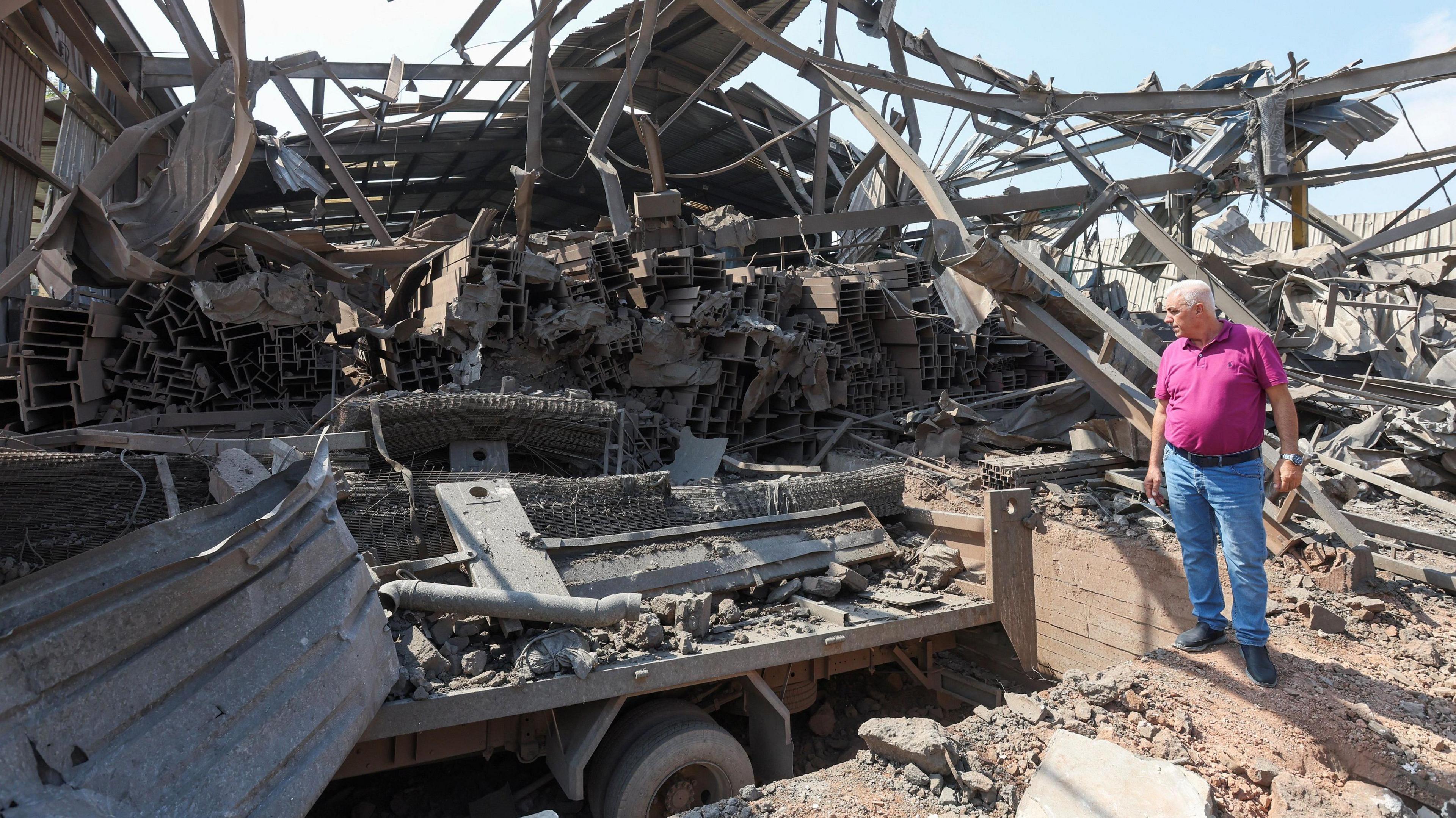 An engineer stands at a damaged site in the aftermath of what Lebanon's health minister said was Israeli air strike in Nabatieh, southern Lebanon.