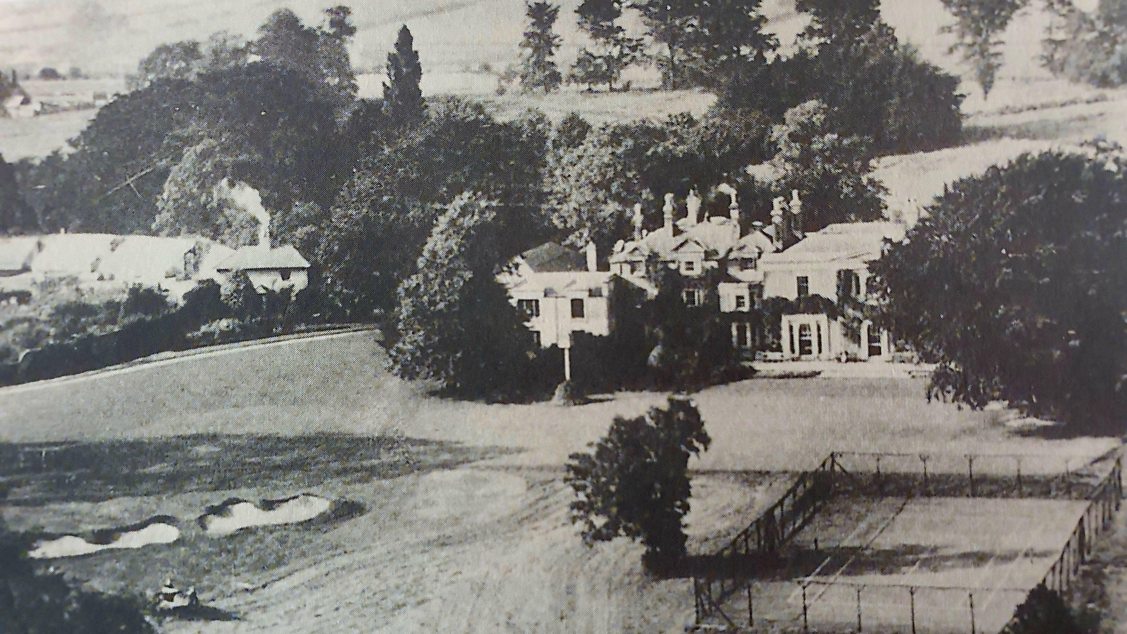 A black and white photograph of the clubhouse, tennis courts and The Walled Garden 