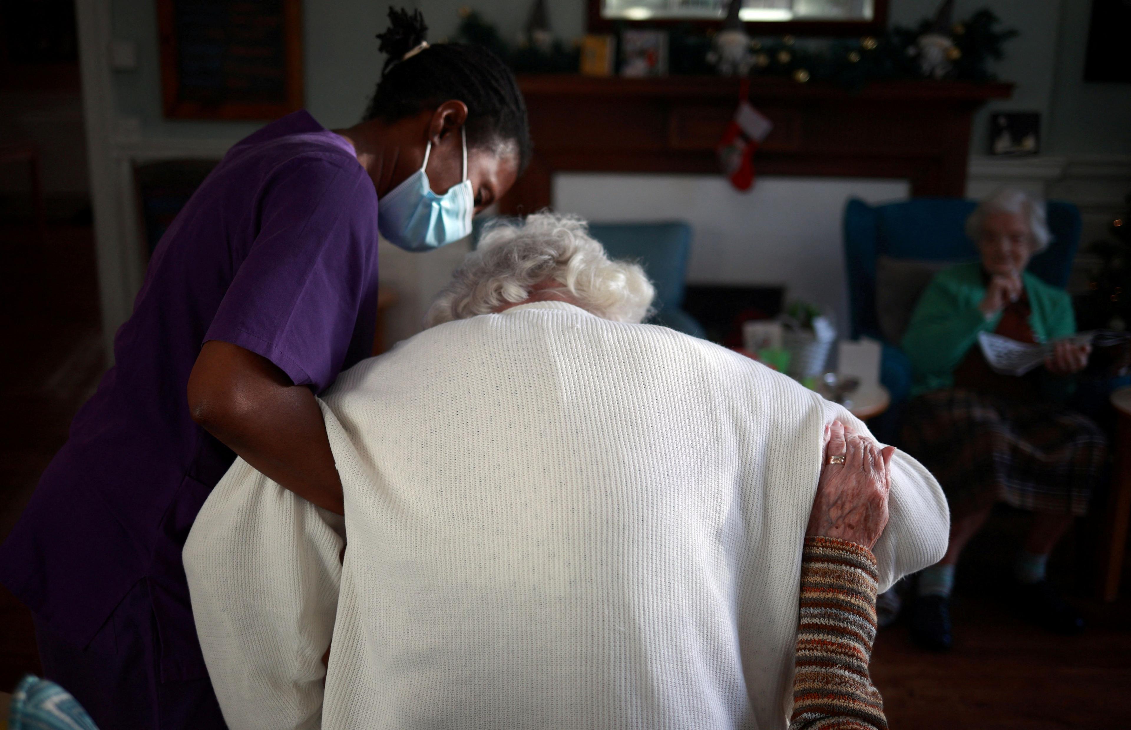 Woman holding elderly lady 