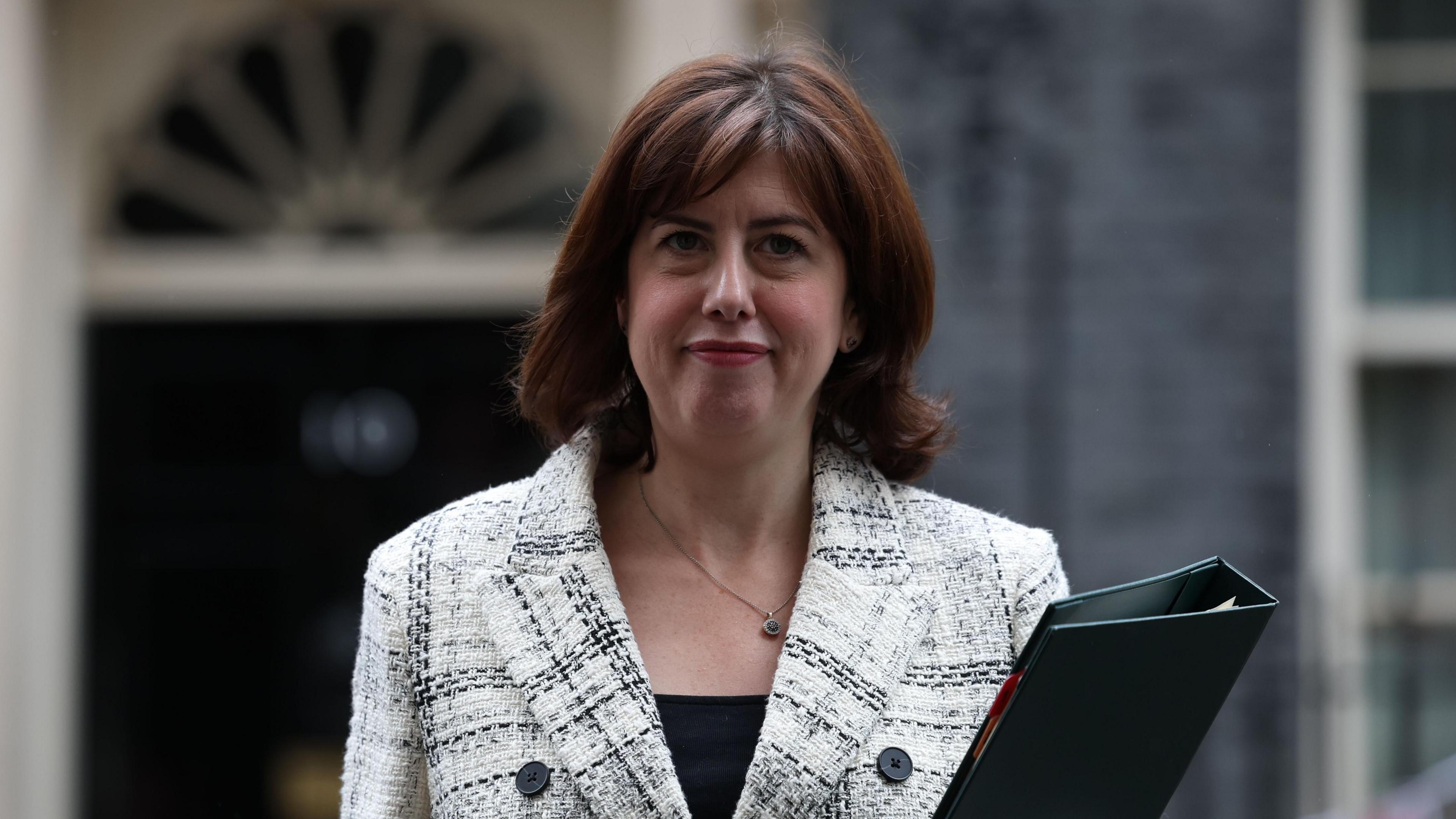 Lucy Powell outside 10 Downing Street holding a black folder.