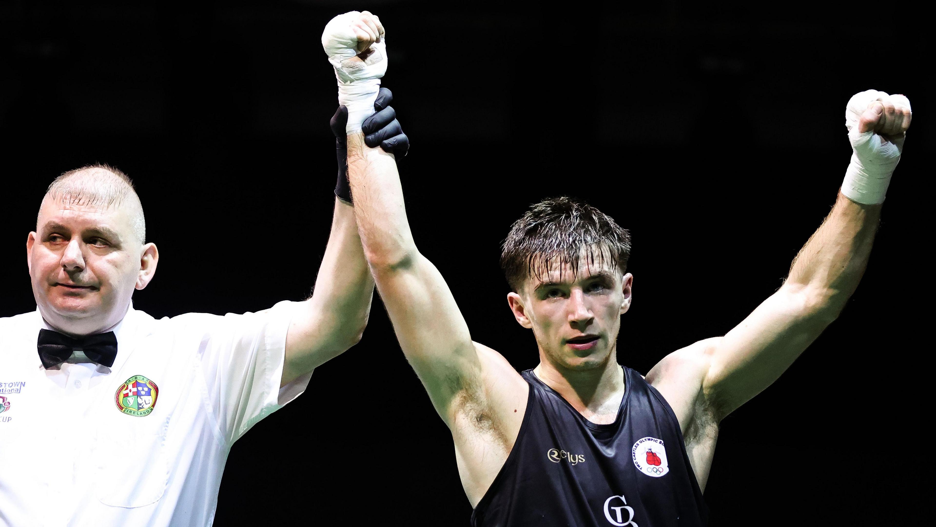 Jude Gallagher has his hand raised in victory