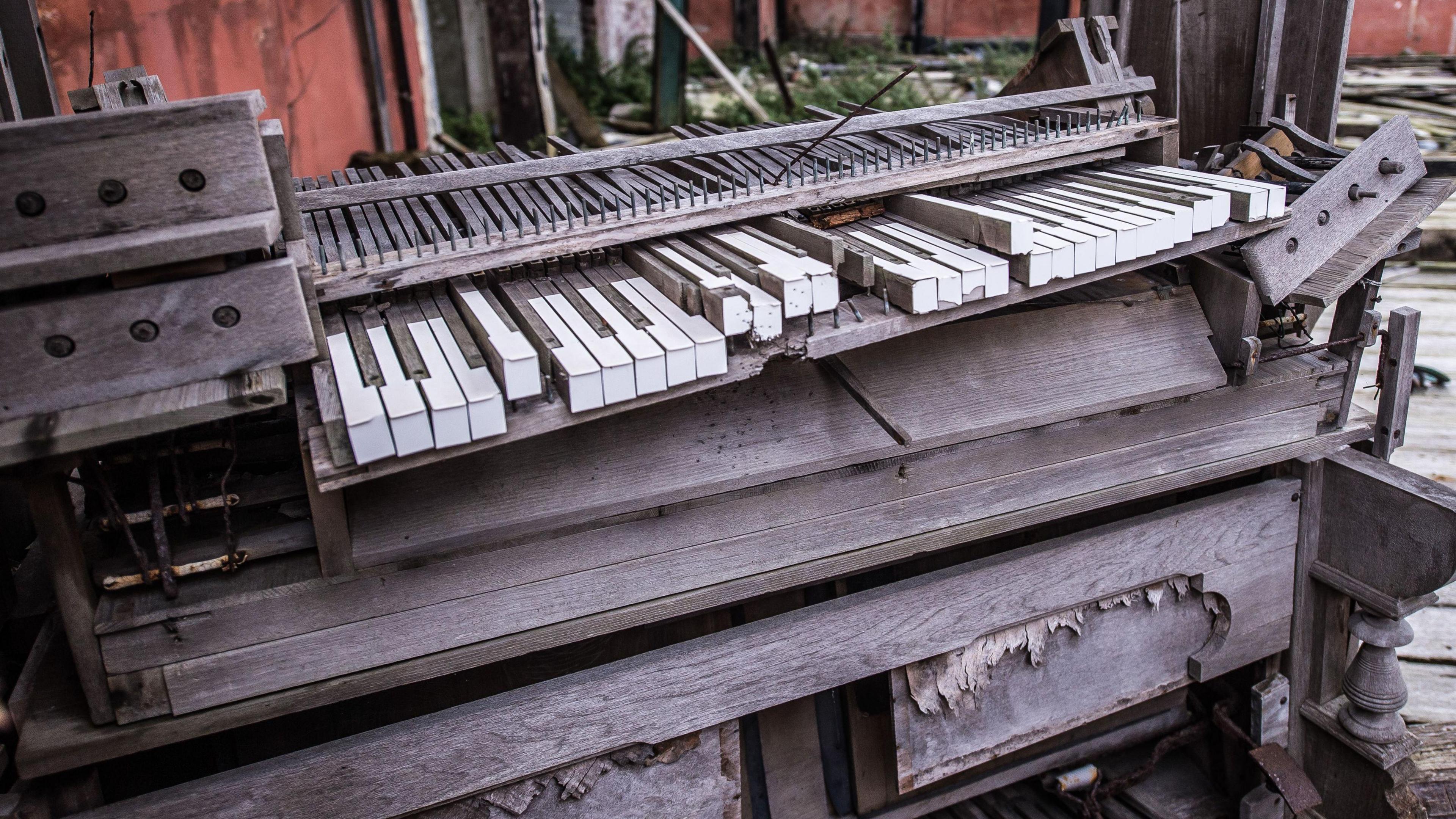 The remains of a musical organ inside the East Pavilion on Birnbeck Pier. It is completely destroyes, with a few tatty keys visible