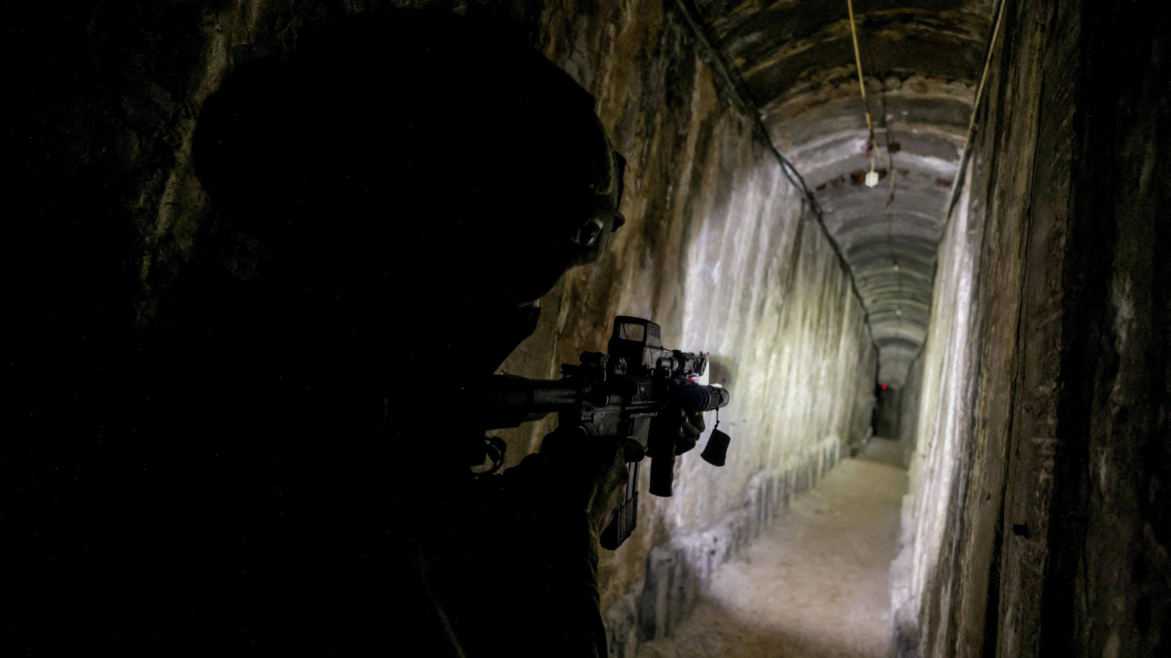 An Israeli soldier secures a tunnel that the Israeli military said ran underneath al-Shifa hospital in Gaza City, northern Gaza (22 November 2023)