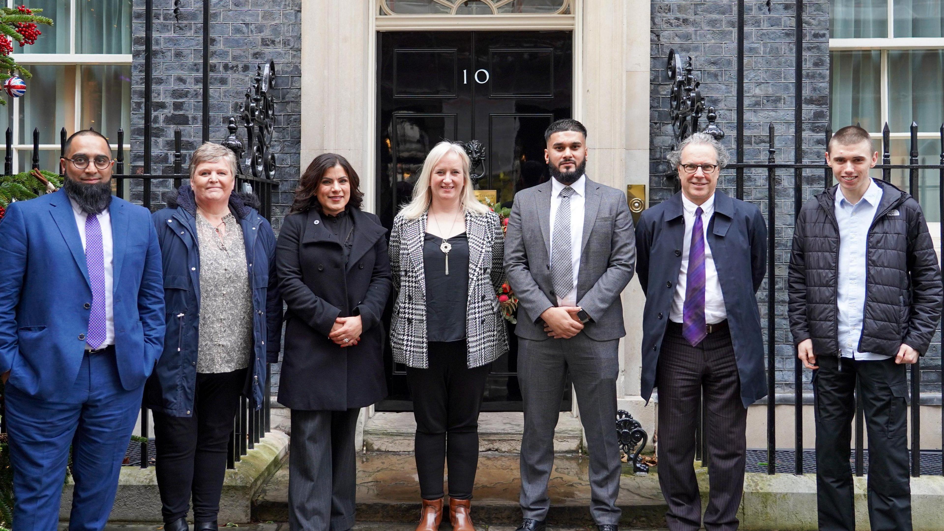 Louis Johnson and six other honourees outside 10 Downing Street