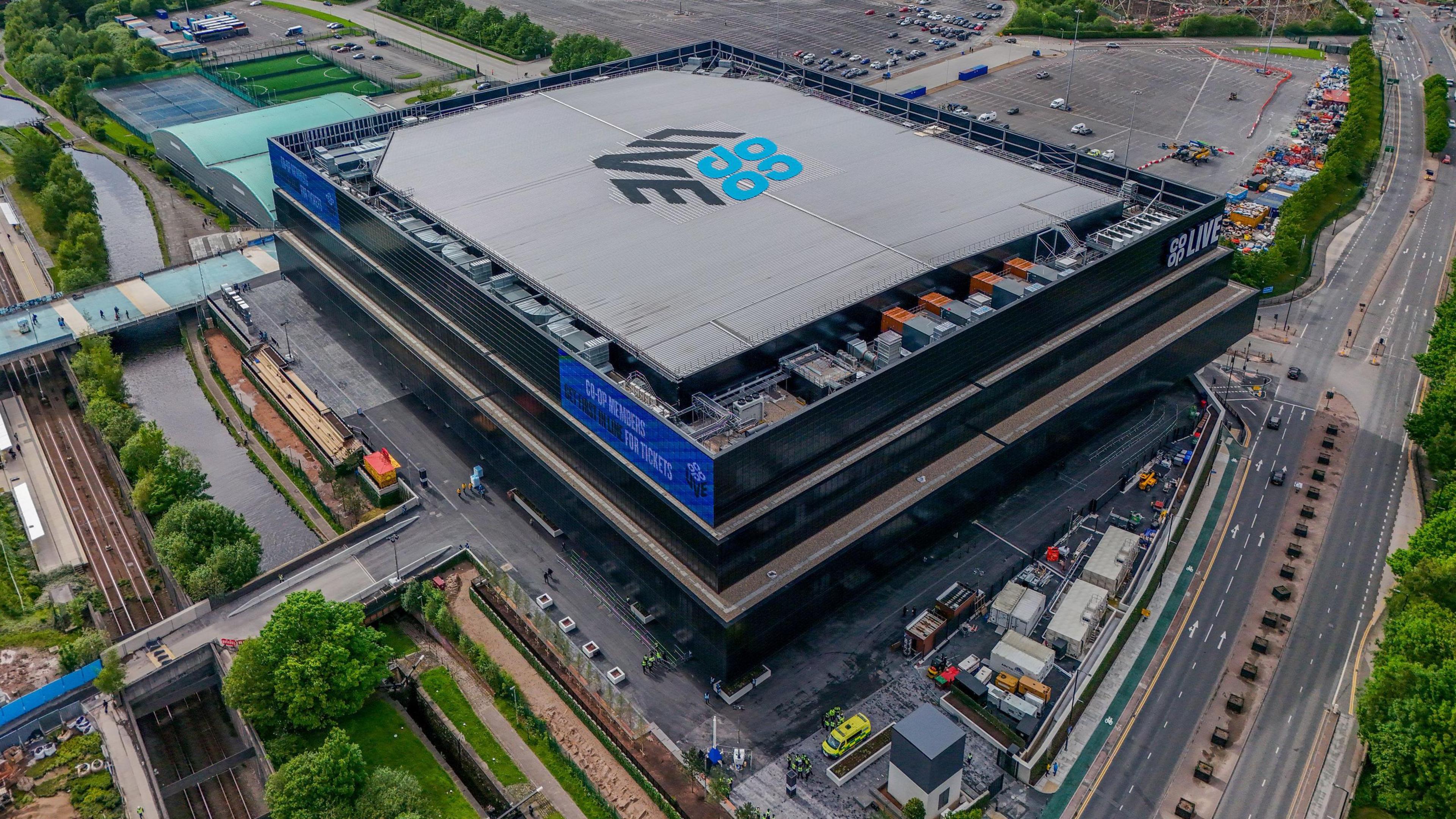 An aerial view of the Co-op Live arena, a black and grey square building