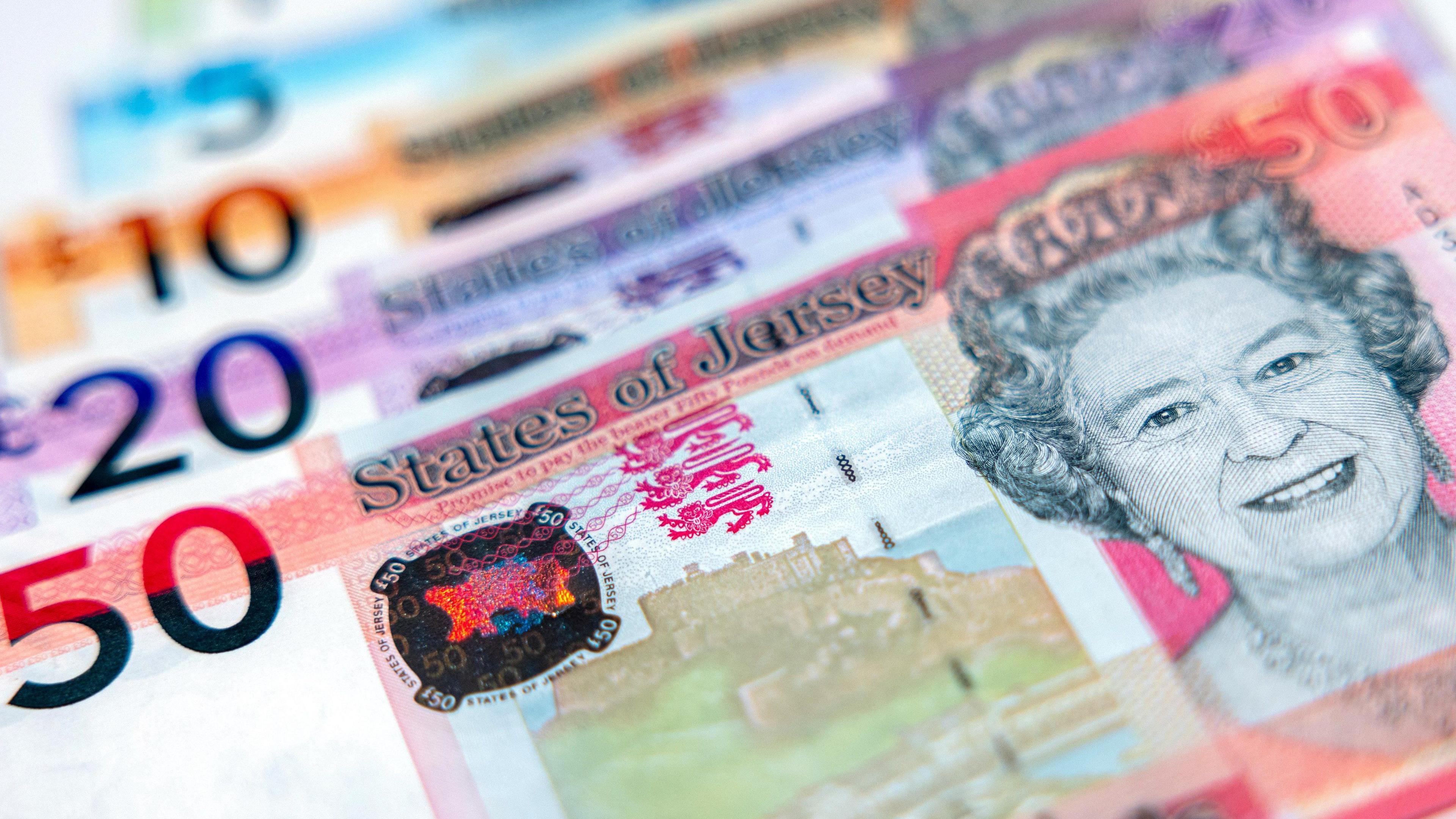 A close up image of various Jersey banknotes featuring Queen Elizabeth II.