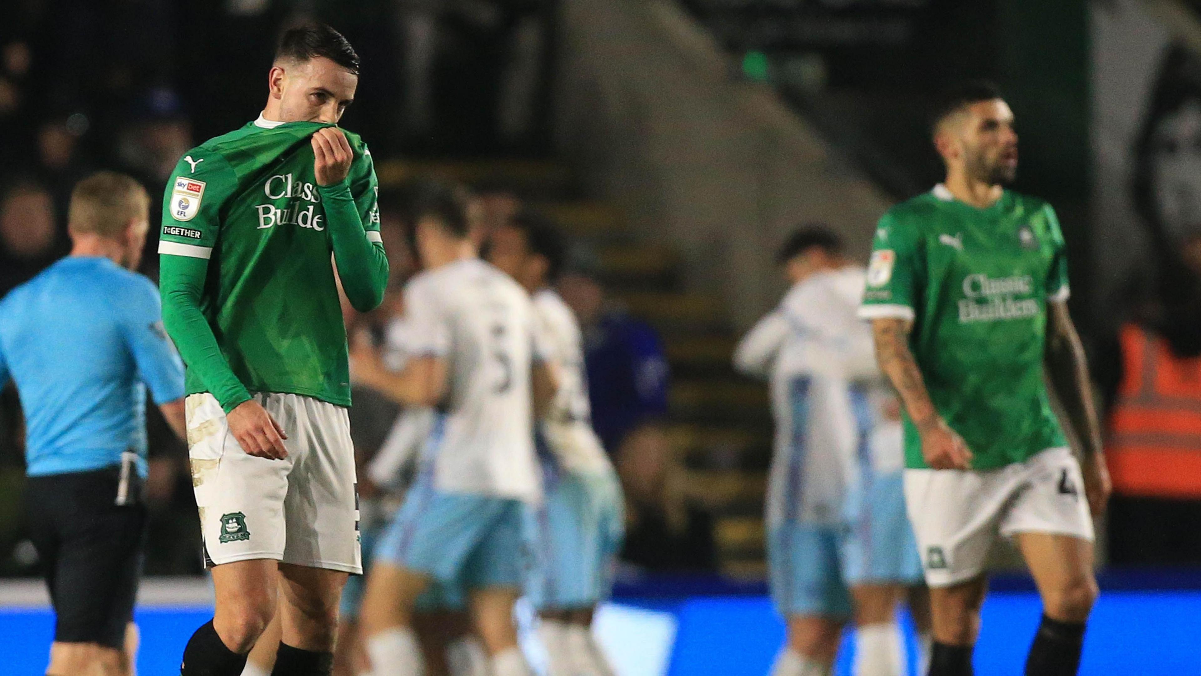 Dejected Plymouth players as Burnley celebrate a goal