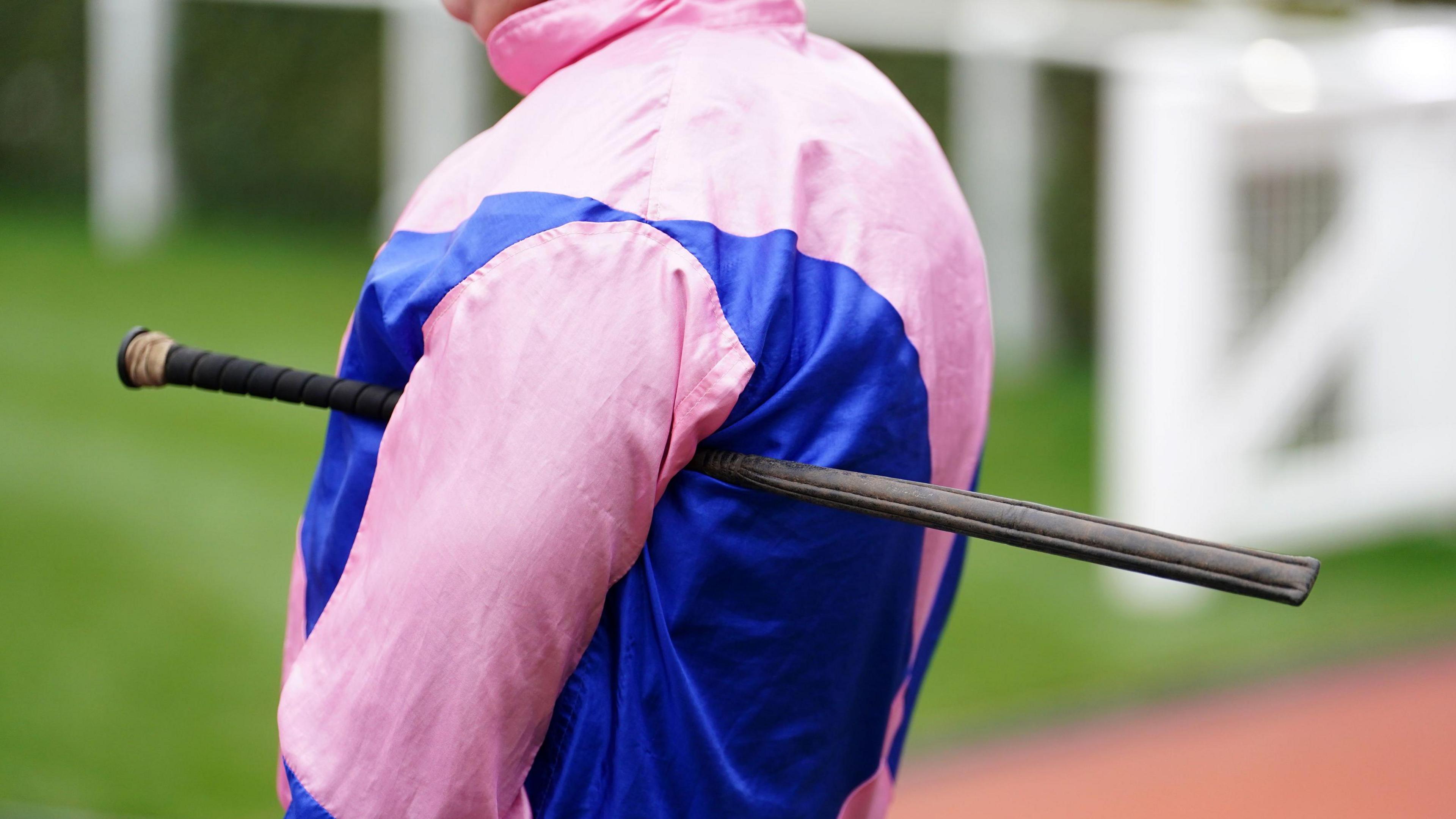 A jockey holding whip