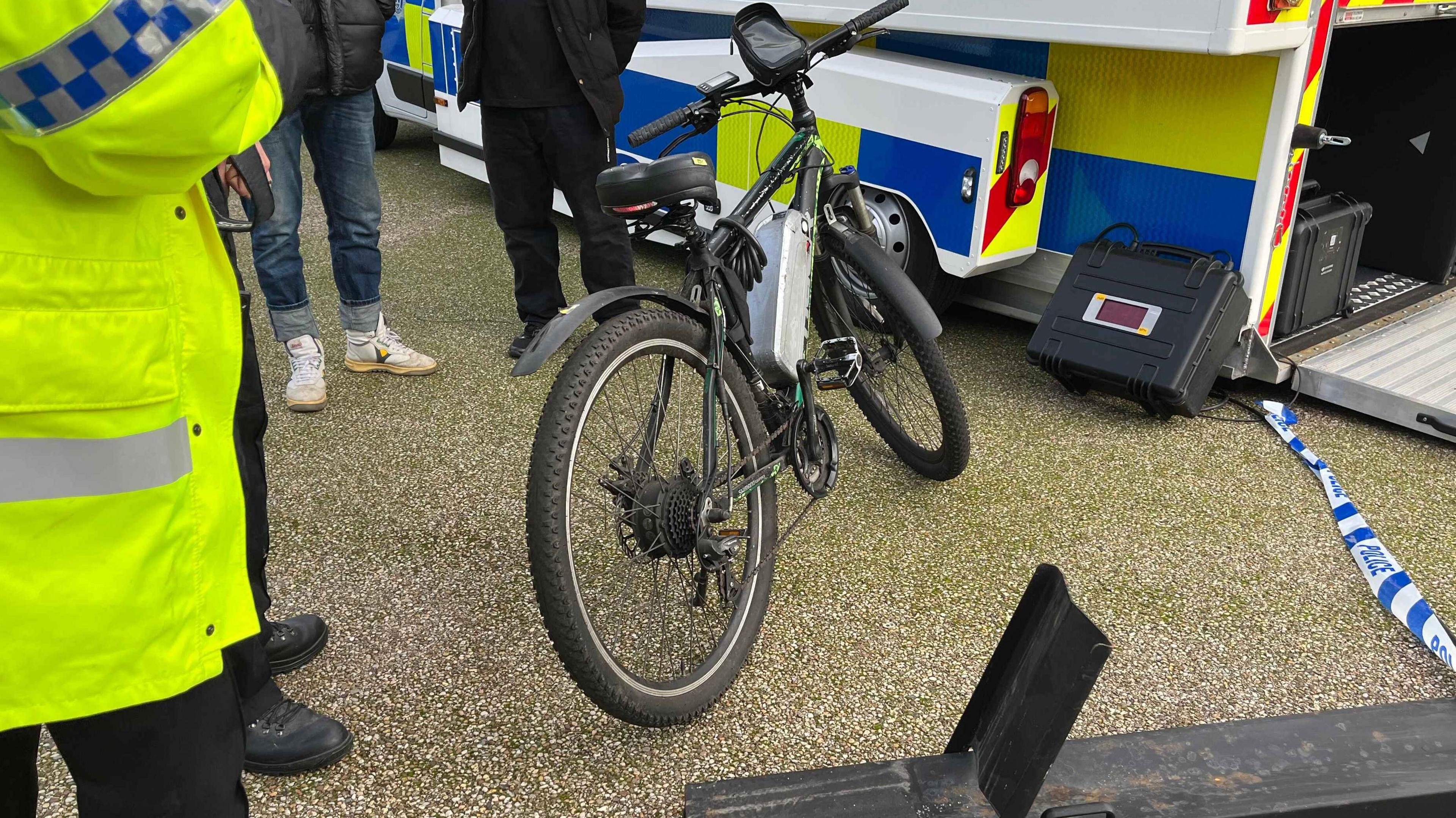A mountain bike with a battery fitted on the frame