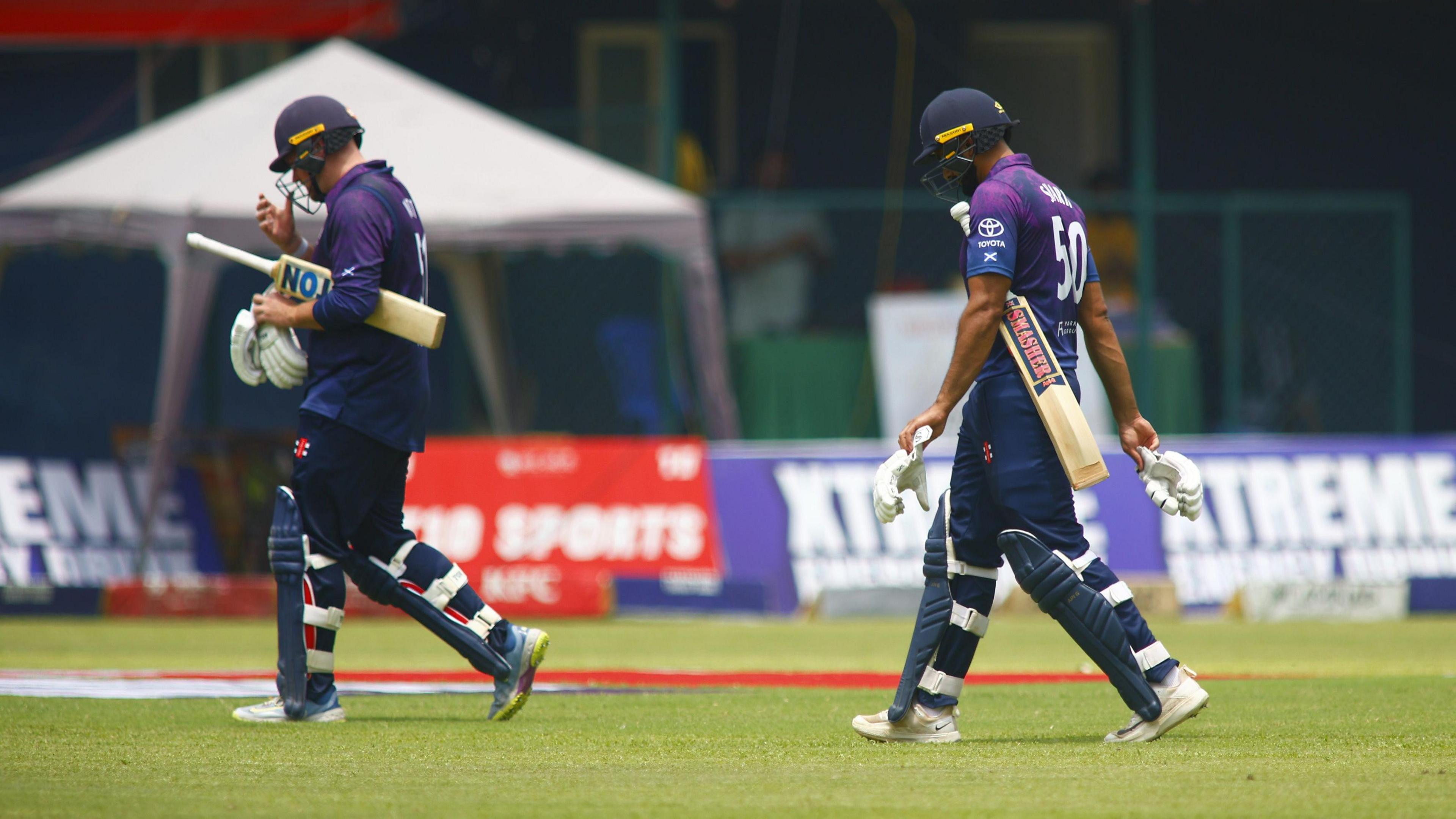 Mark Watt and Safyaan Sharif walk off after Scotland were bowled out