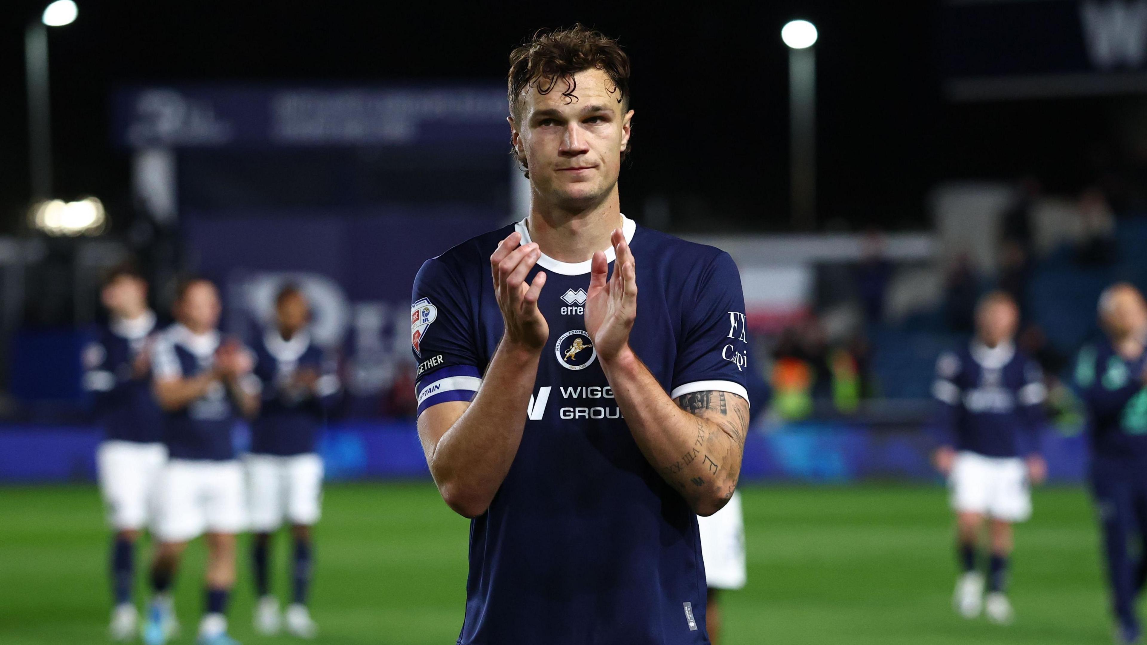 Millwall captain Jake Cooper applauds the fans, looking dejected after they were beaten by Hull City