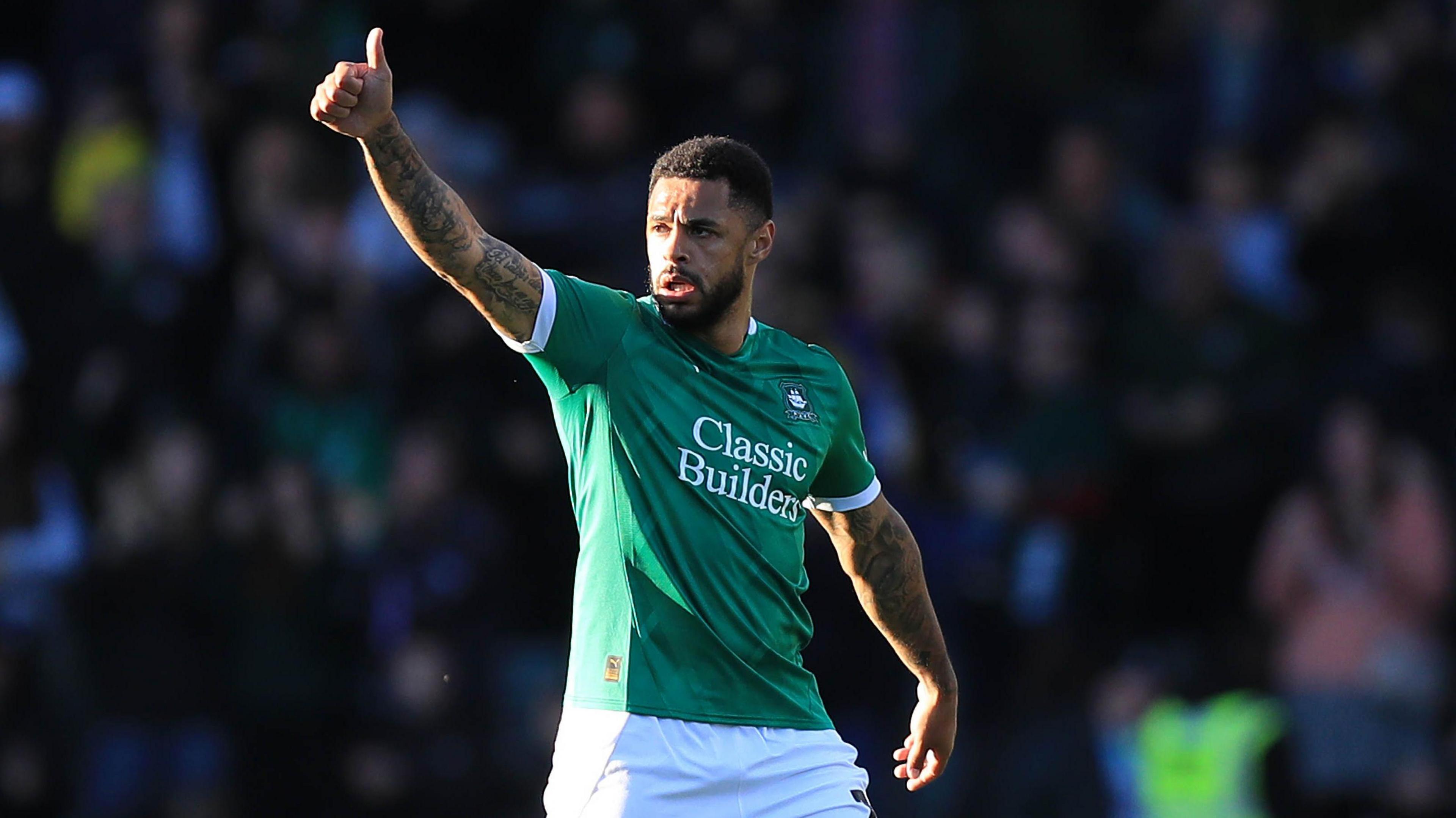 Andre Gray holds his thumb up