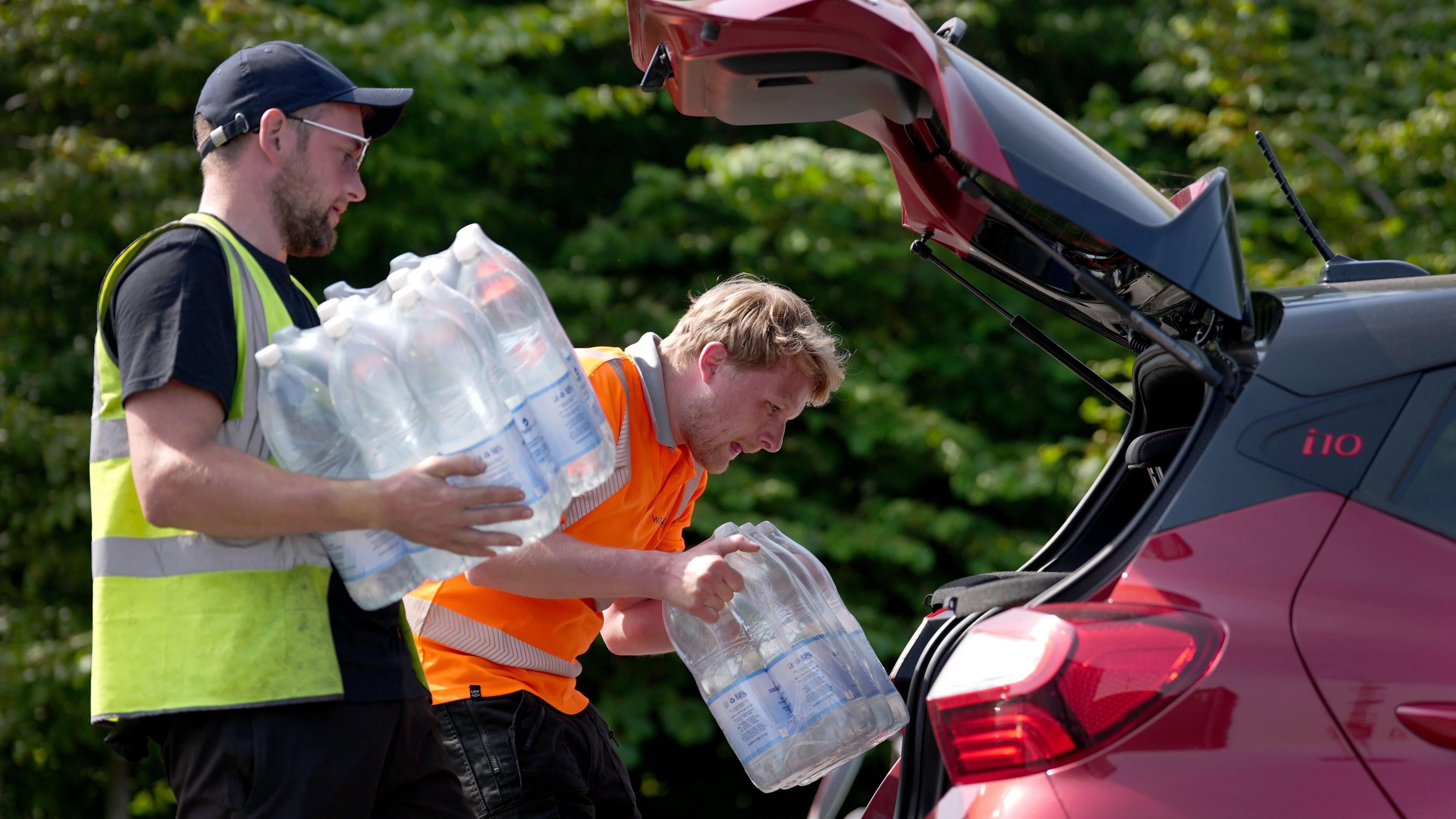South East Water staff handout bottled water at a water collection point near Herne Bay
