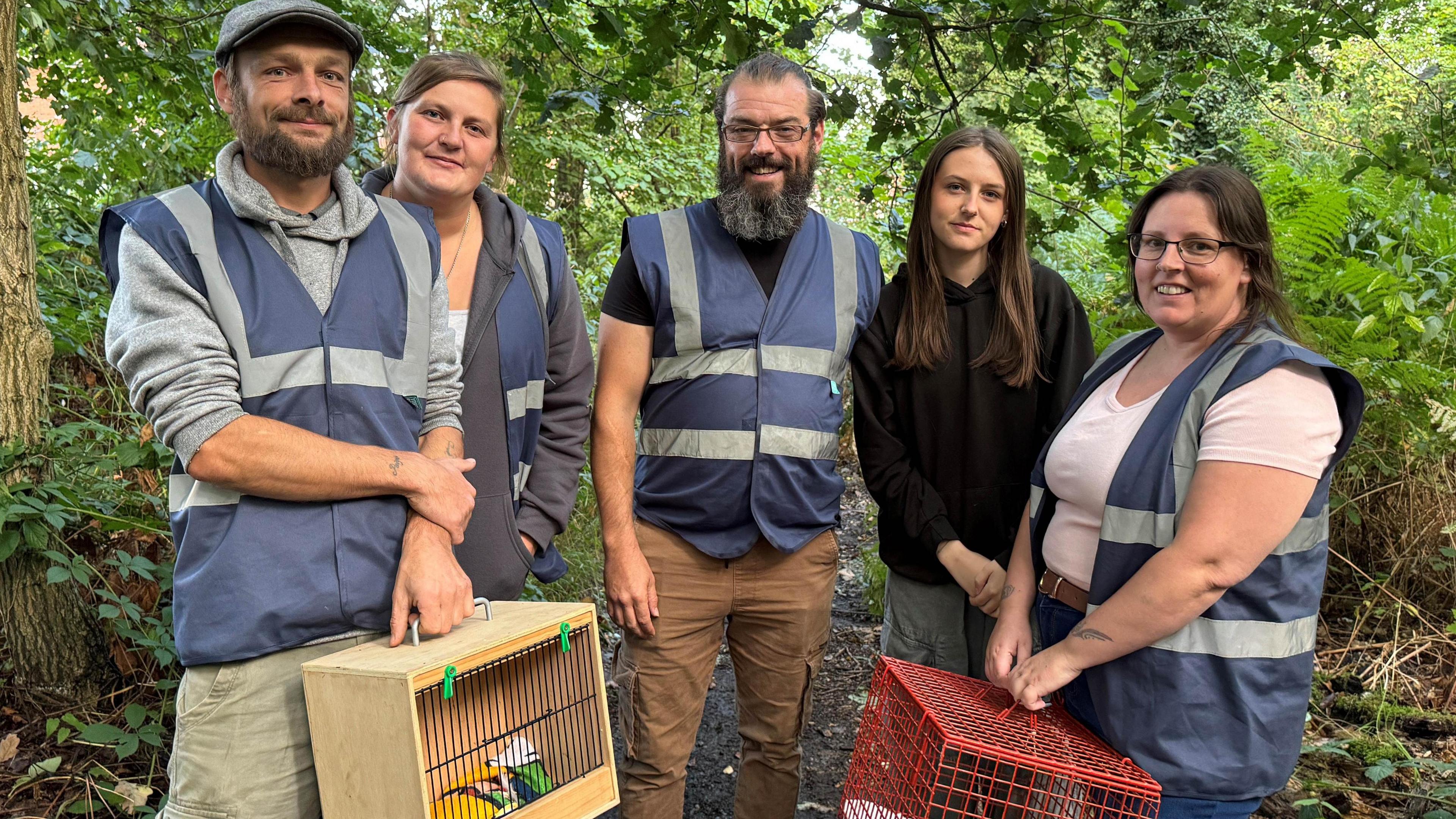 A family in a woodland who have just released three birds back into their habitat in Warsop in Nottinghamshire