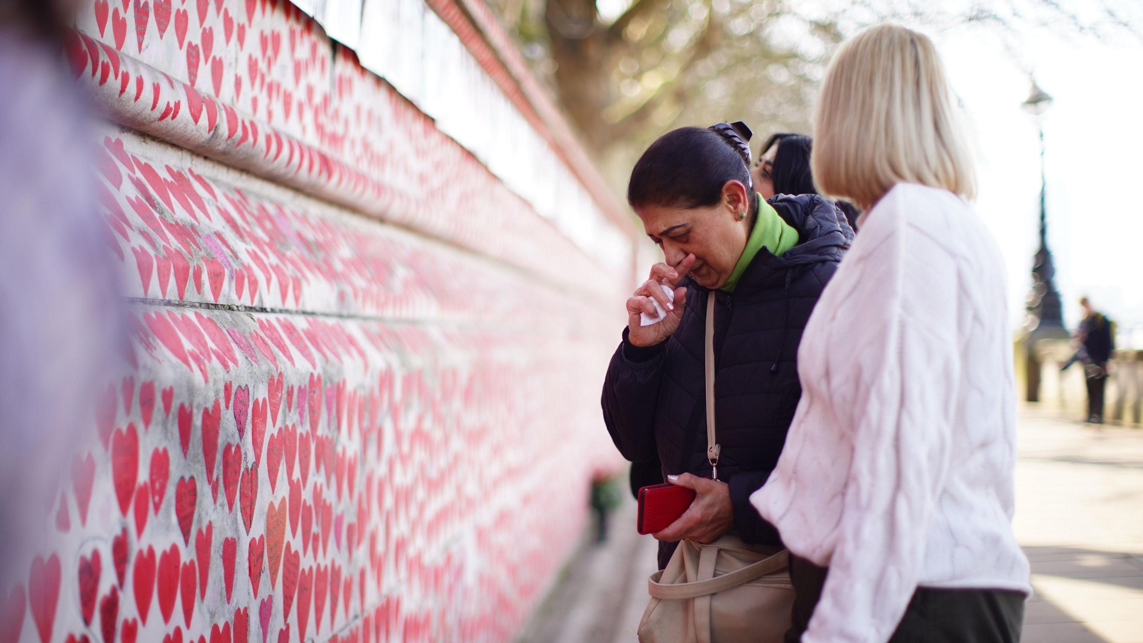 People at the National Covid Memorial Wall in London before a ceremony marking the fifth anniversary of the Covid-19 pandemic. Picture date: Sunday March 9, 2025.