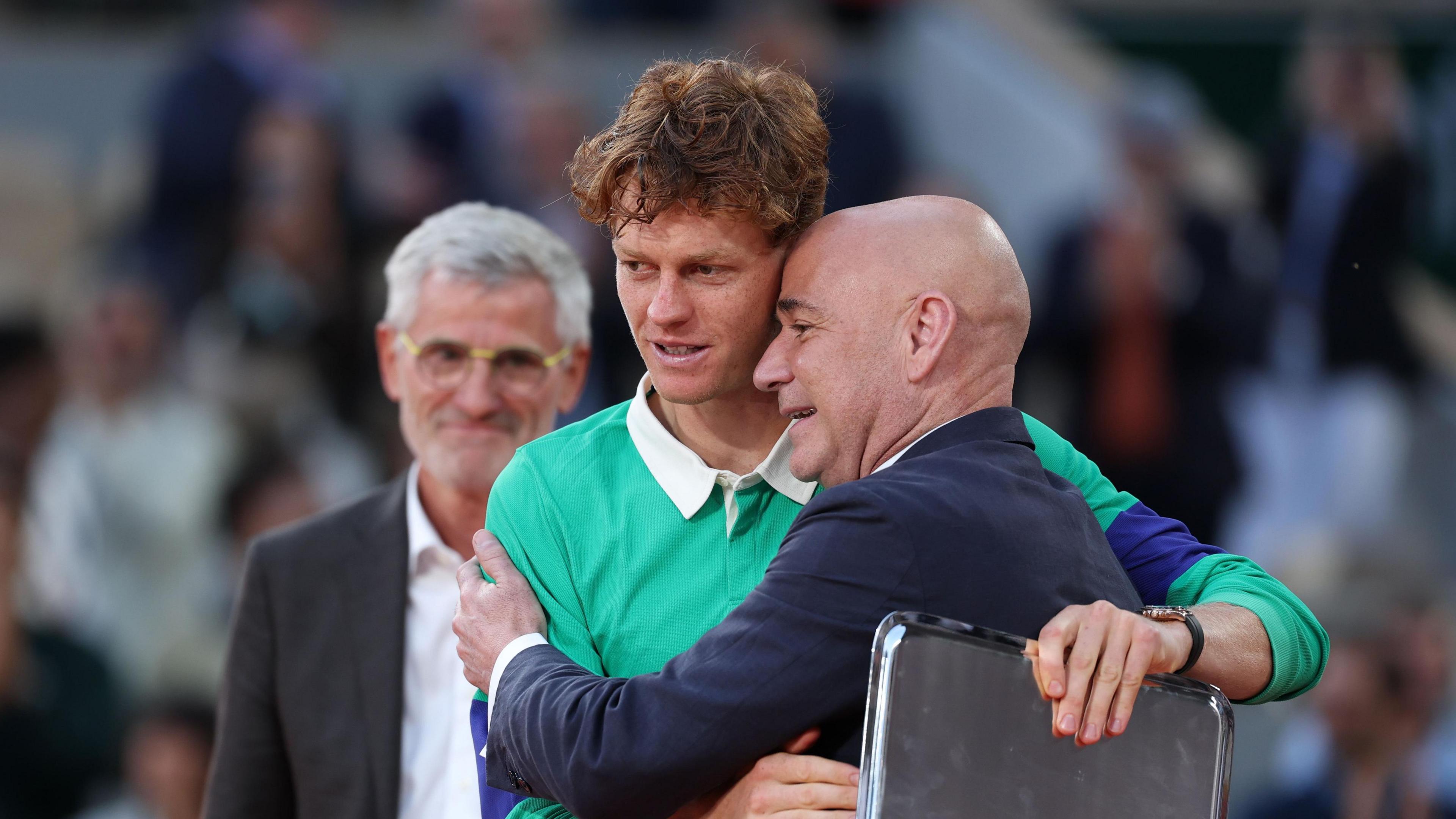 Jannik Sinner is consoled by Andre Agassi after the 2025 French Open final