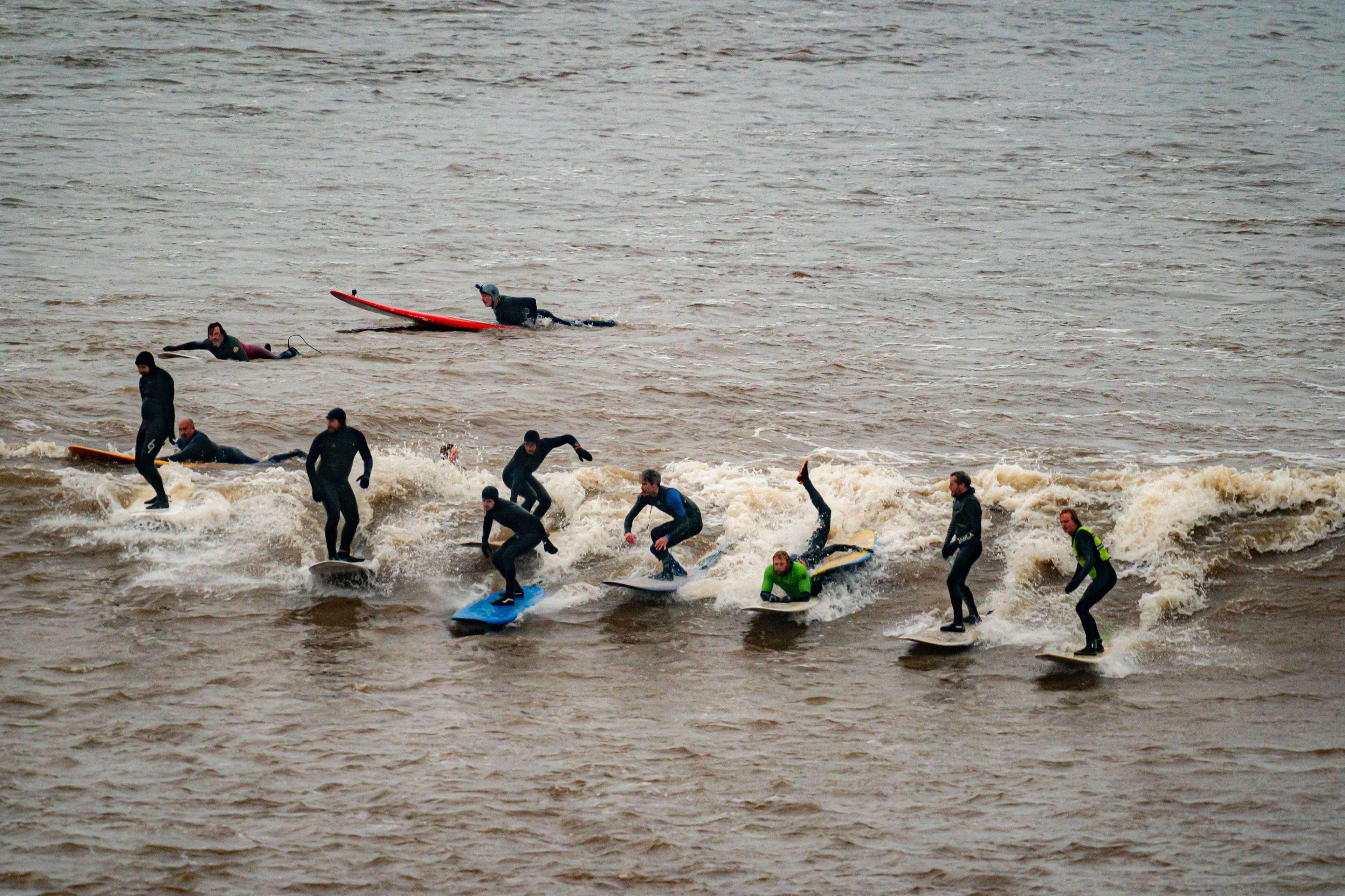 A group of 11 surfers ride the Severn Bore, a tidal wave on the River Severn