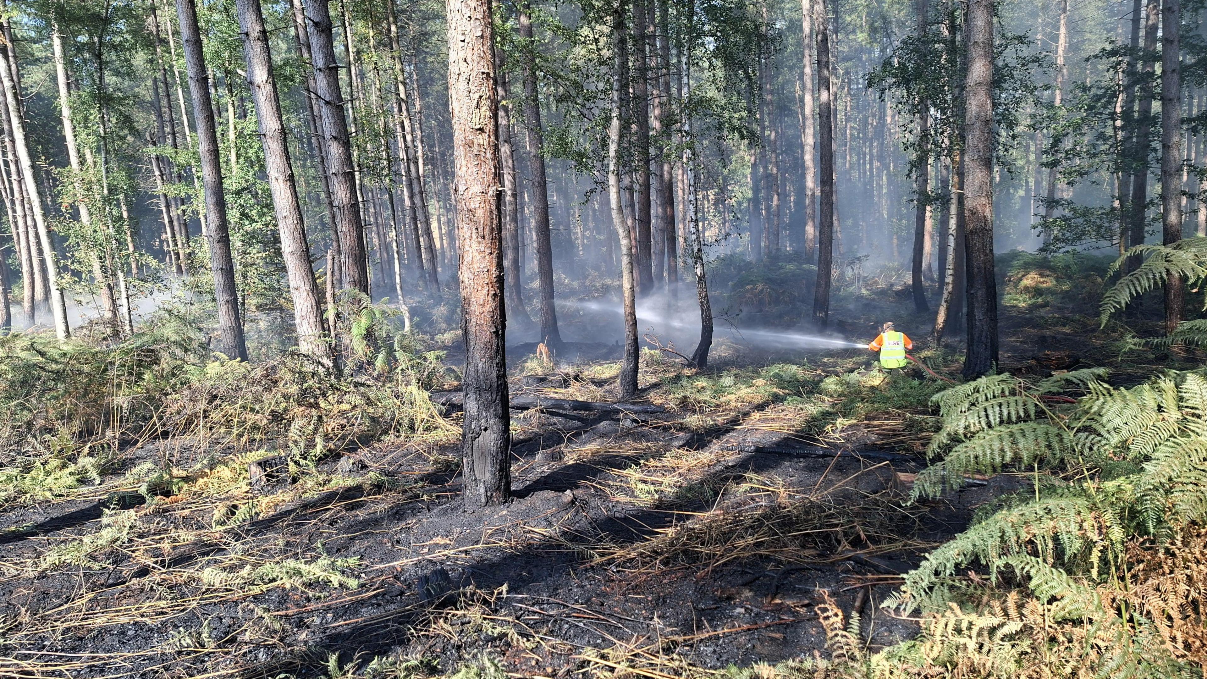Firefighter tackling a fire at Wood End Lane, in Stanton-by-Bridge, Derbyshire.