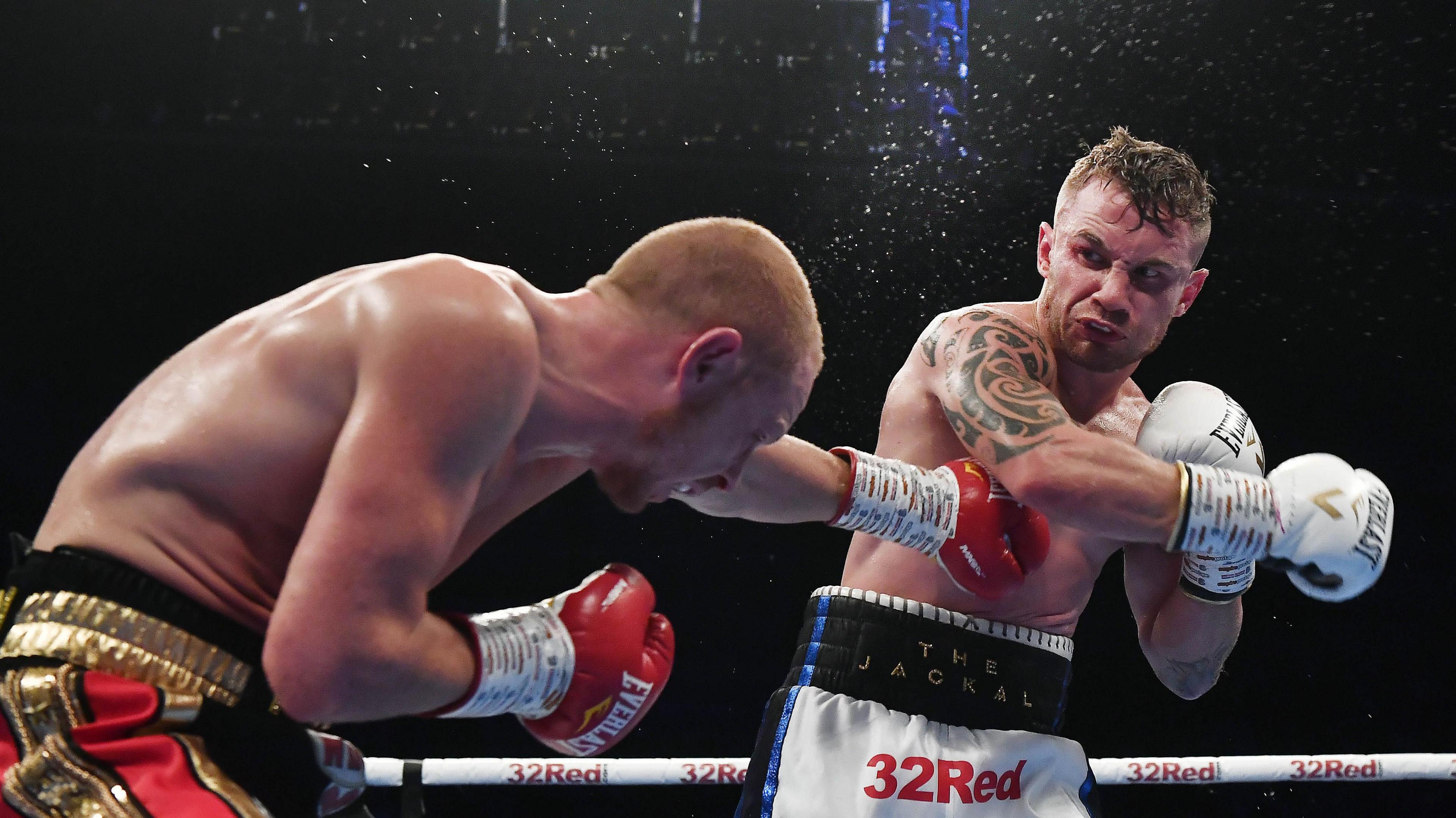 Carl Frampton punches Luke Jackson during their fight at Windsor Park in 2018