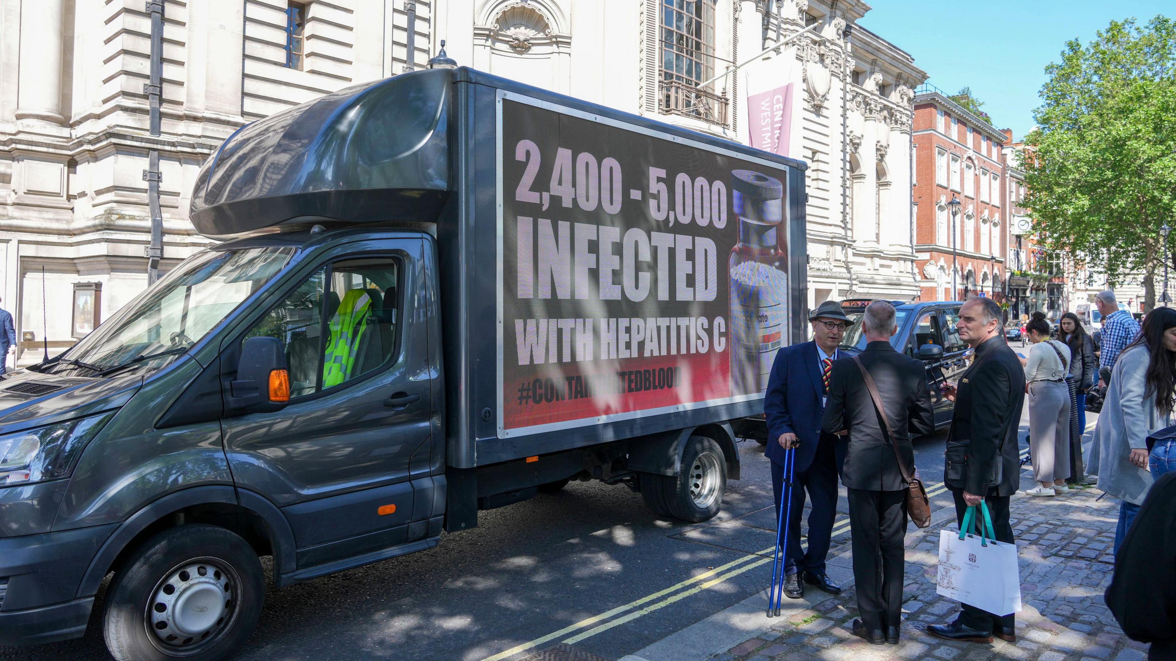 A van parked in London with a poster highlighting the number of infections 