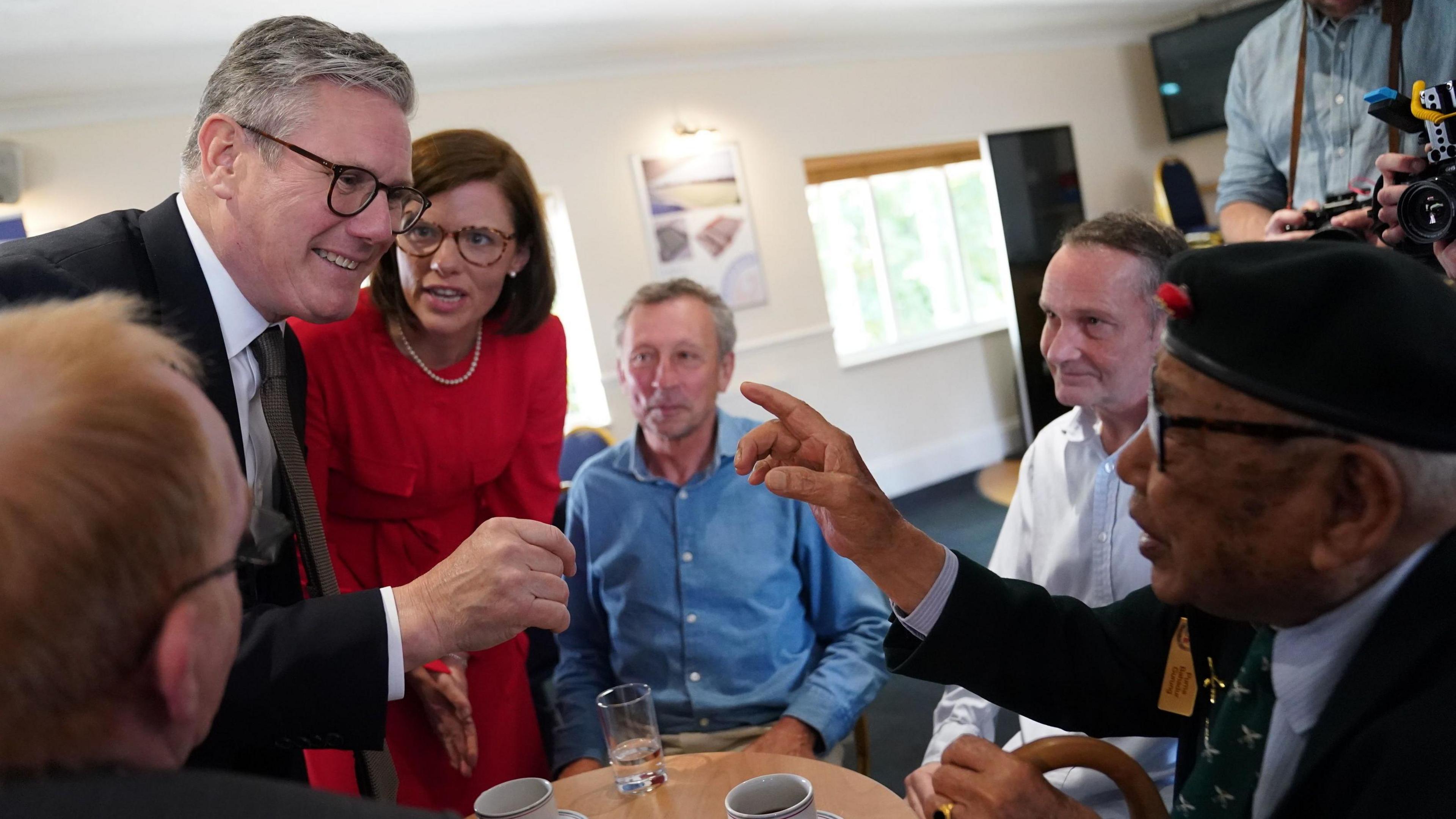 Labour leader Sir Keir Starmer meeting a veteran at a coffee morning at Aldershot Town Football Club