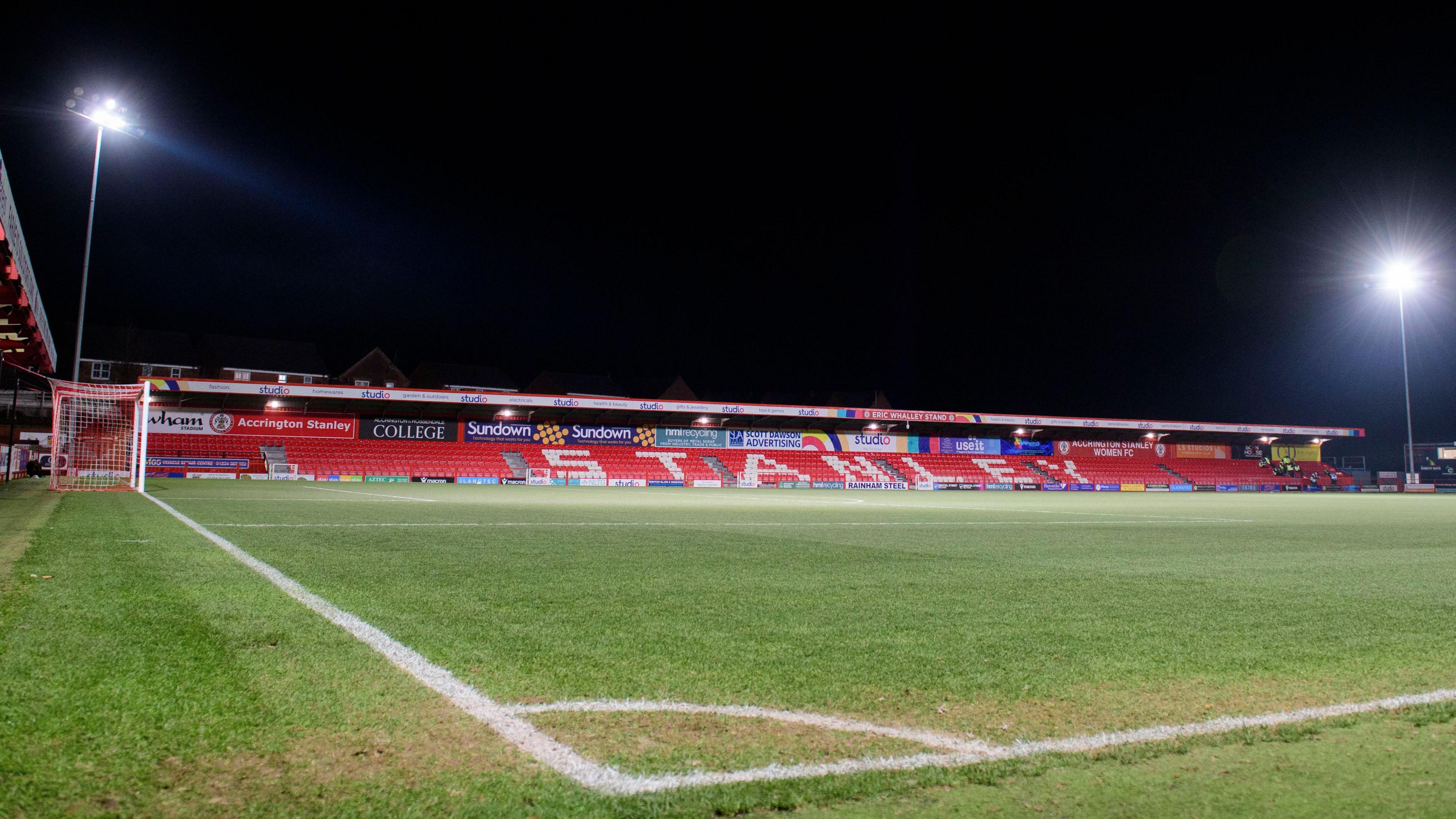 A view of Accrington Stanley's Wham Stadium under floodlights