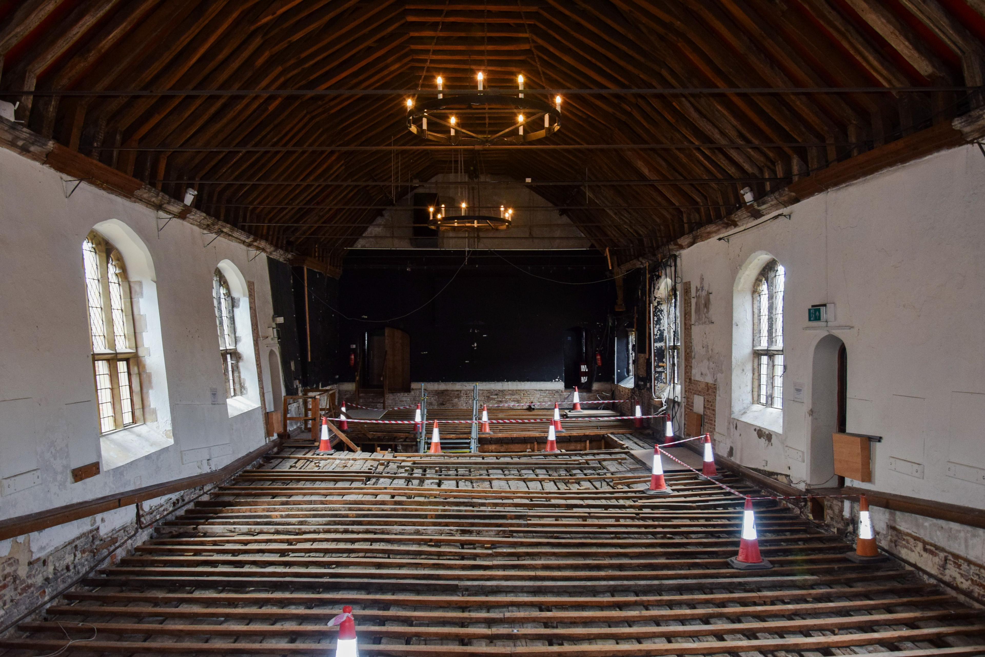 Interior of St Georges Guildhall. The floor has been taken up to show the Medieval wooden slats which would have formed the original stage. 