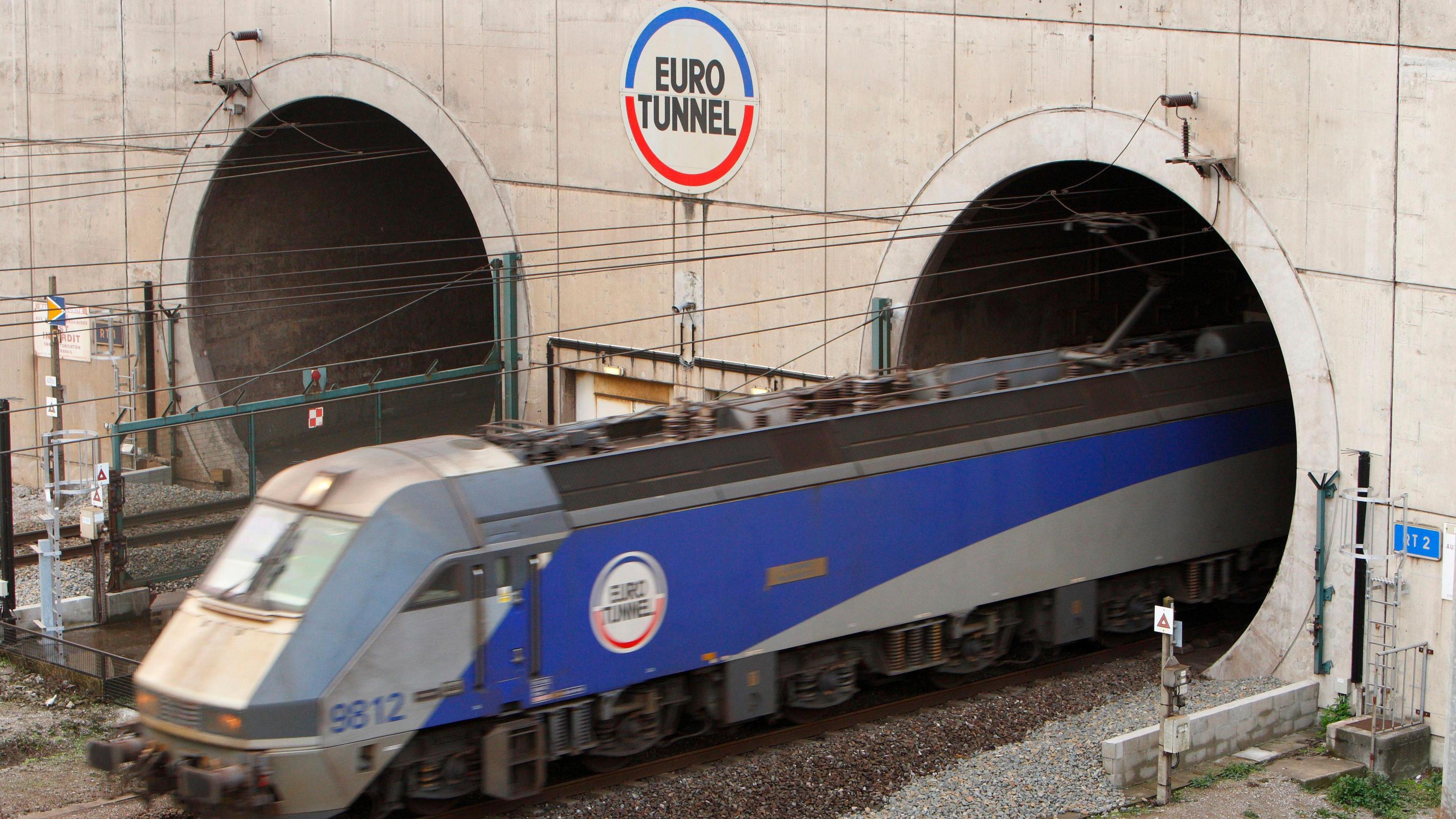 A train leaving the Eurotunnel at Coquelles in France, in the blue and grey livery of Channel Tunnel company Eurotunnel
