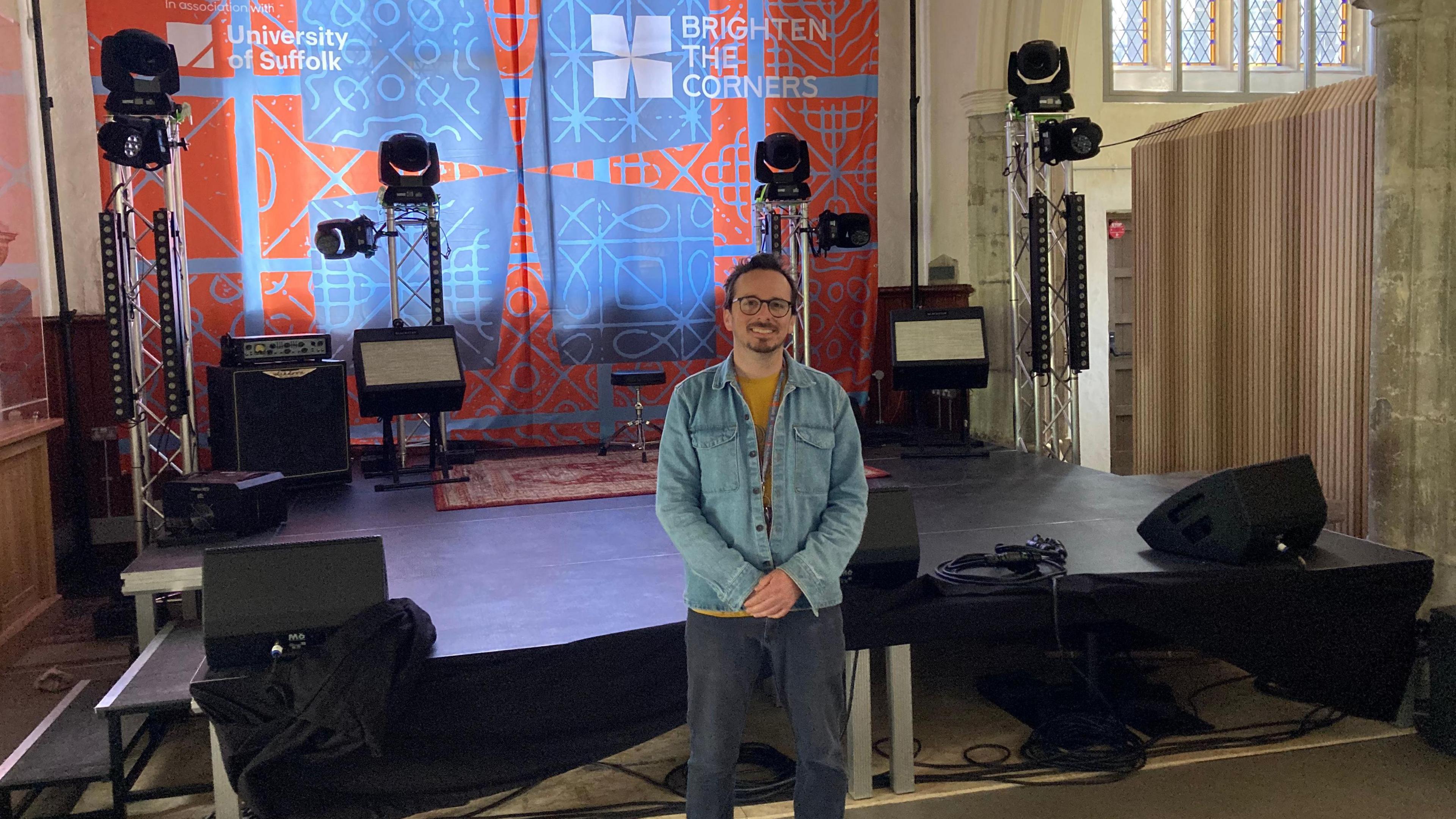 Brighten the Corners organiser Joe Bailey stands in front of a stage