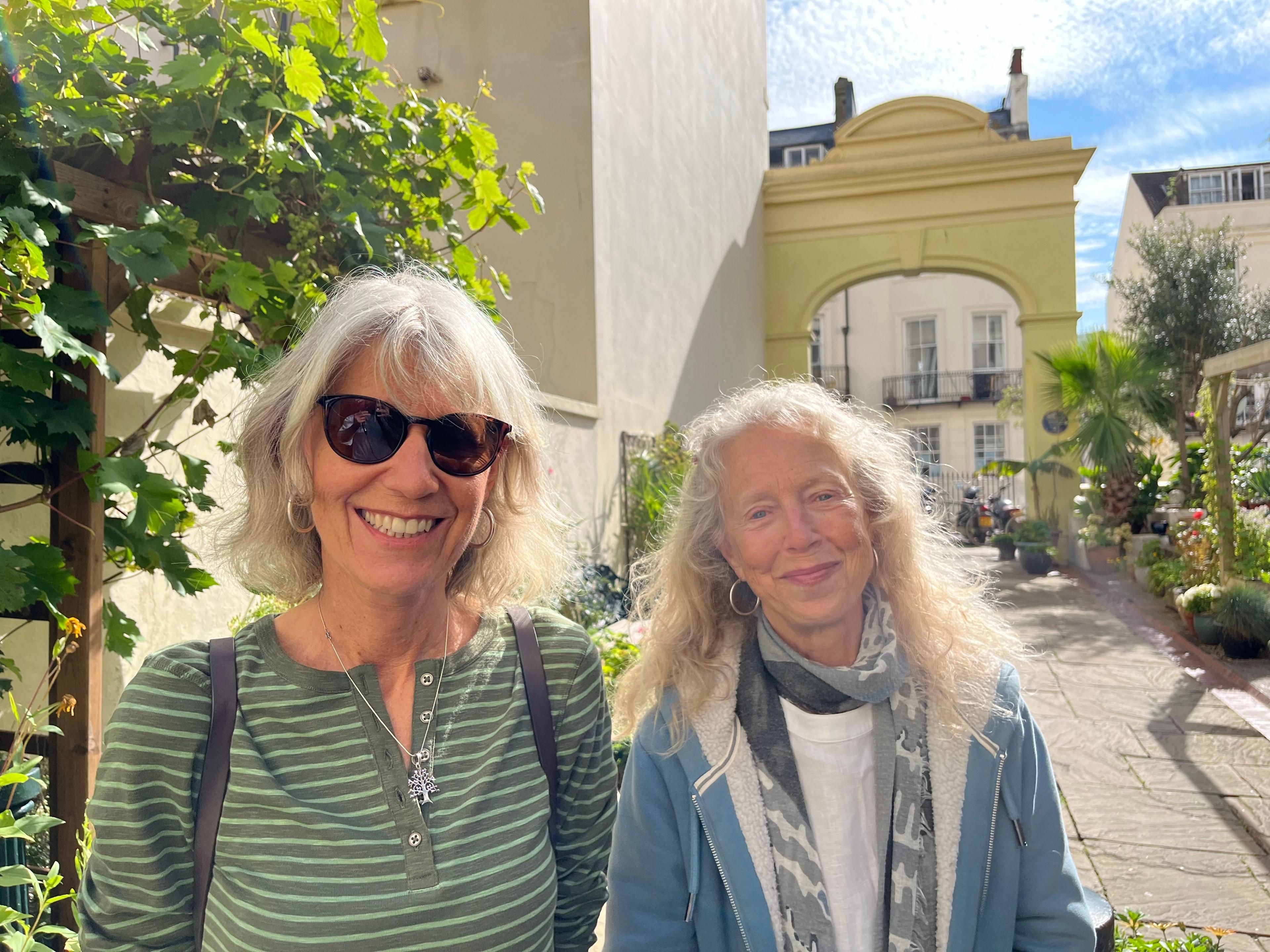 Jenny Granville and her sister Judy standing in the garden with plants around them