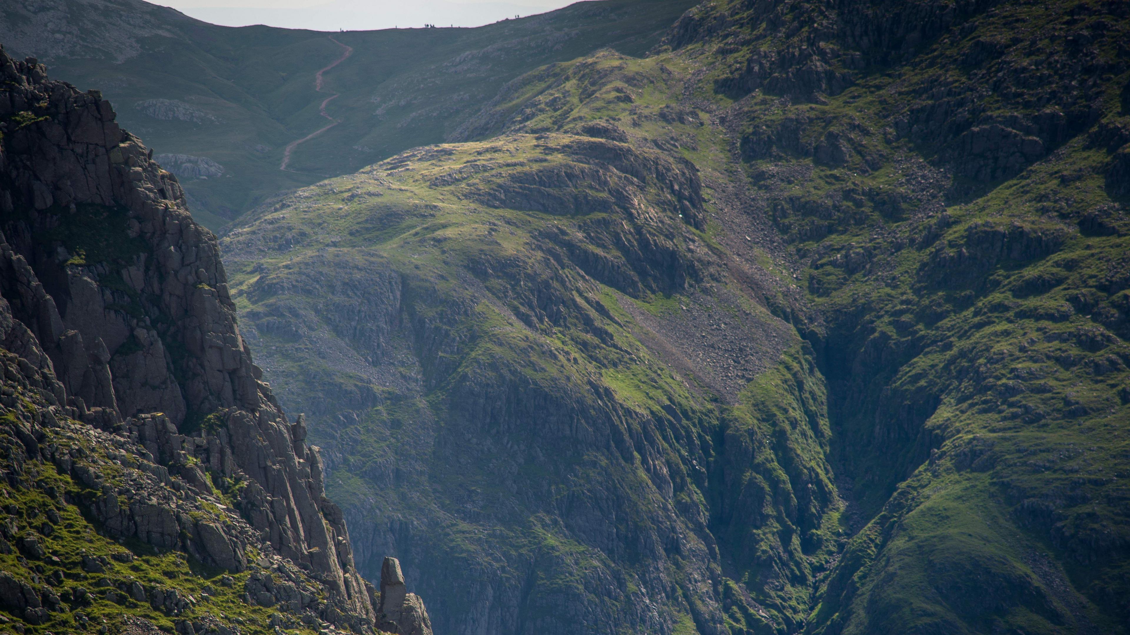 The view of Piers Gill, showing a deep ravine, with Scafell Pike in the background