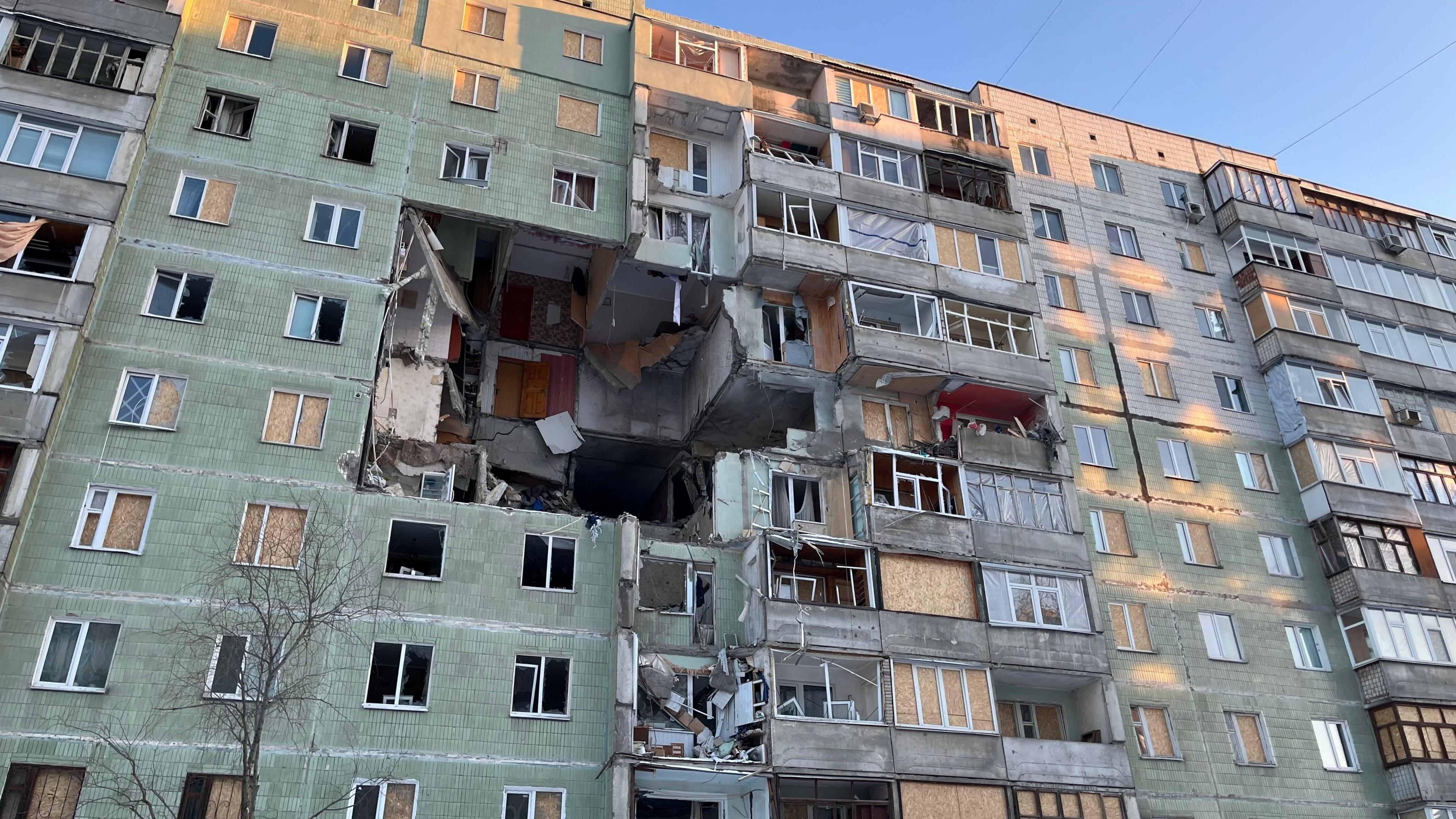 An apartment block with a huge hole caused by a Russian weapons