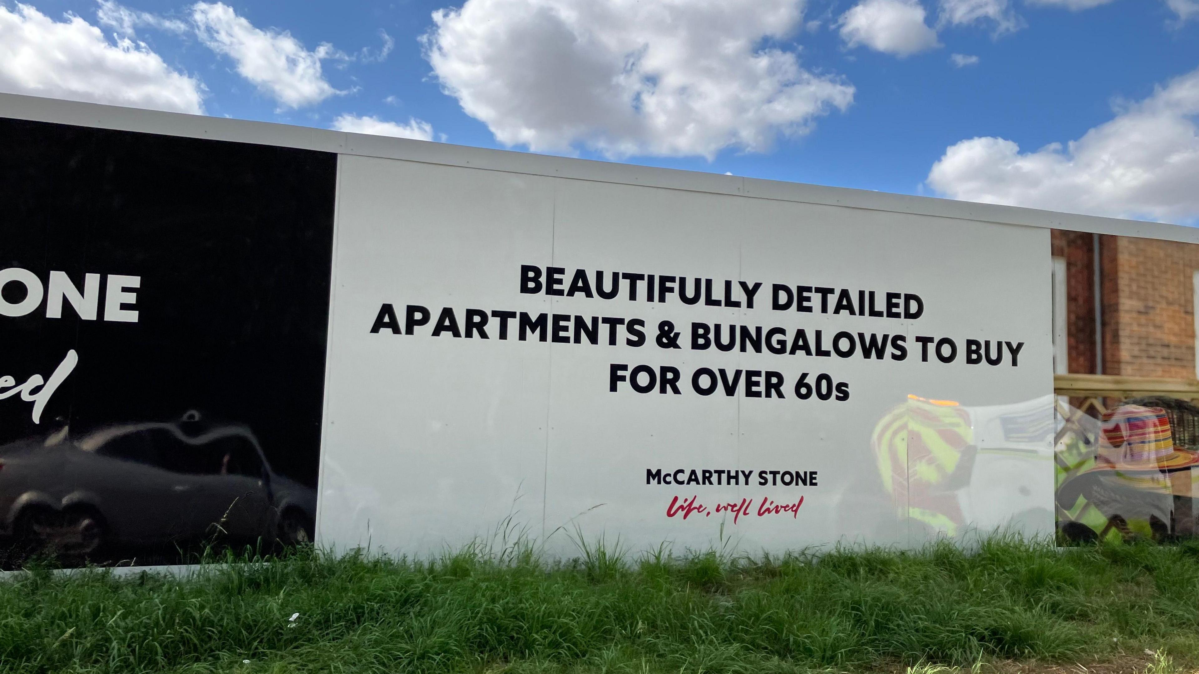 Boarding around a building site reads "Beautifully detailed apartments and bungalows to buy for over 60s"  