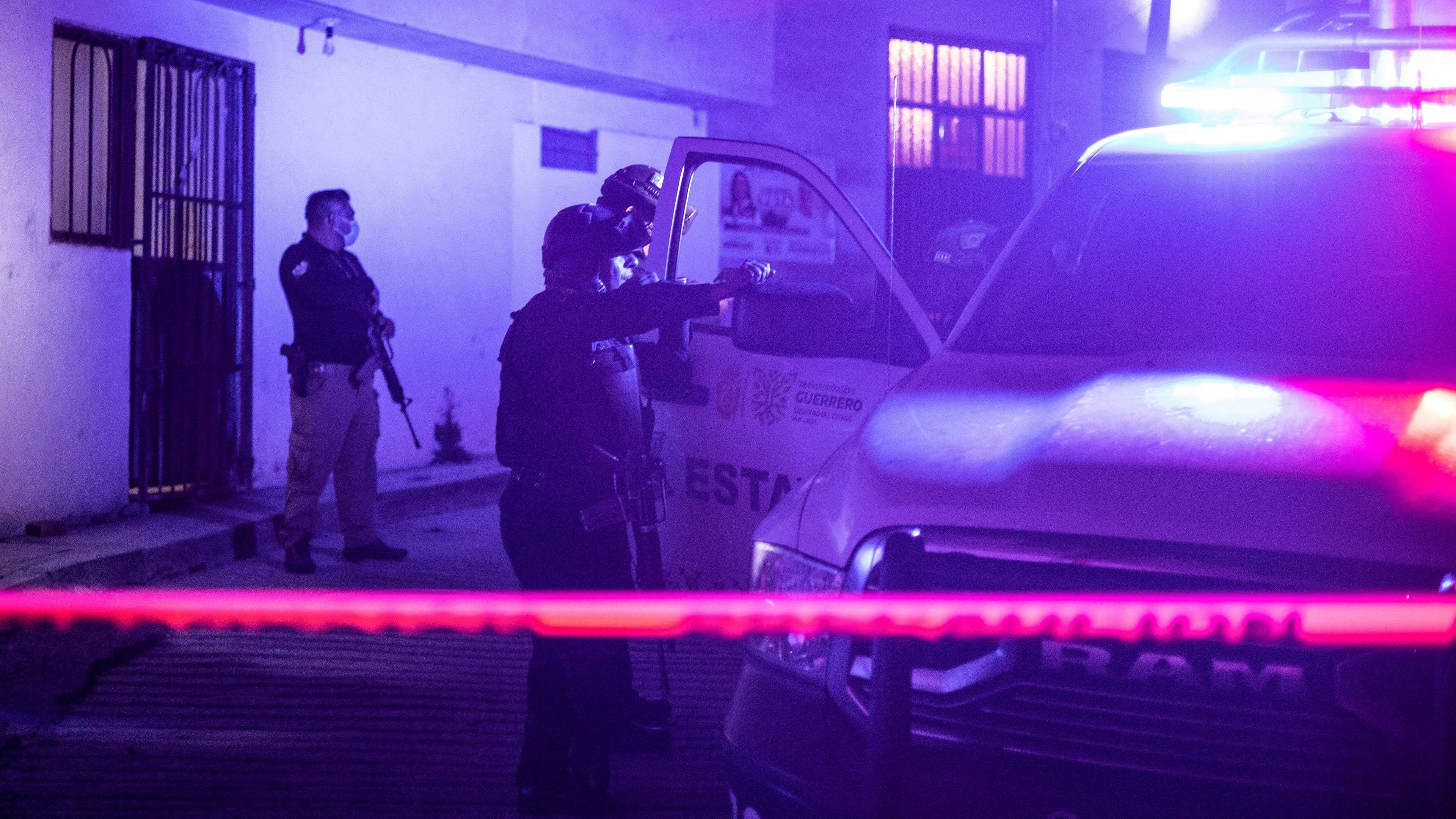 Armed police stand at the crime scene where the remains of Arcos were found in Chilpancingo, Mexico