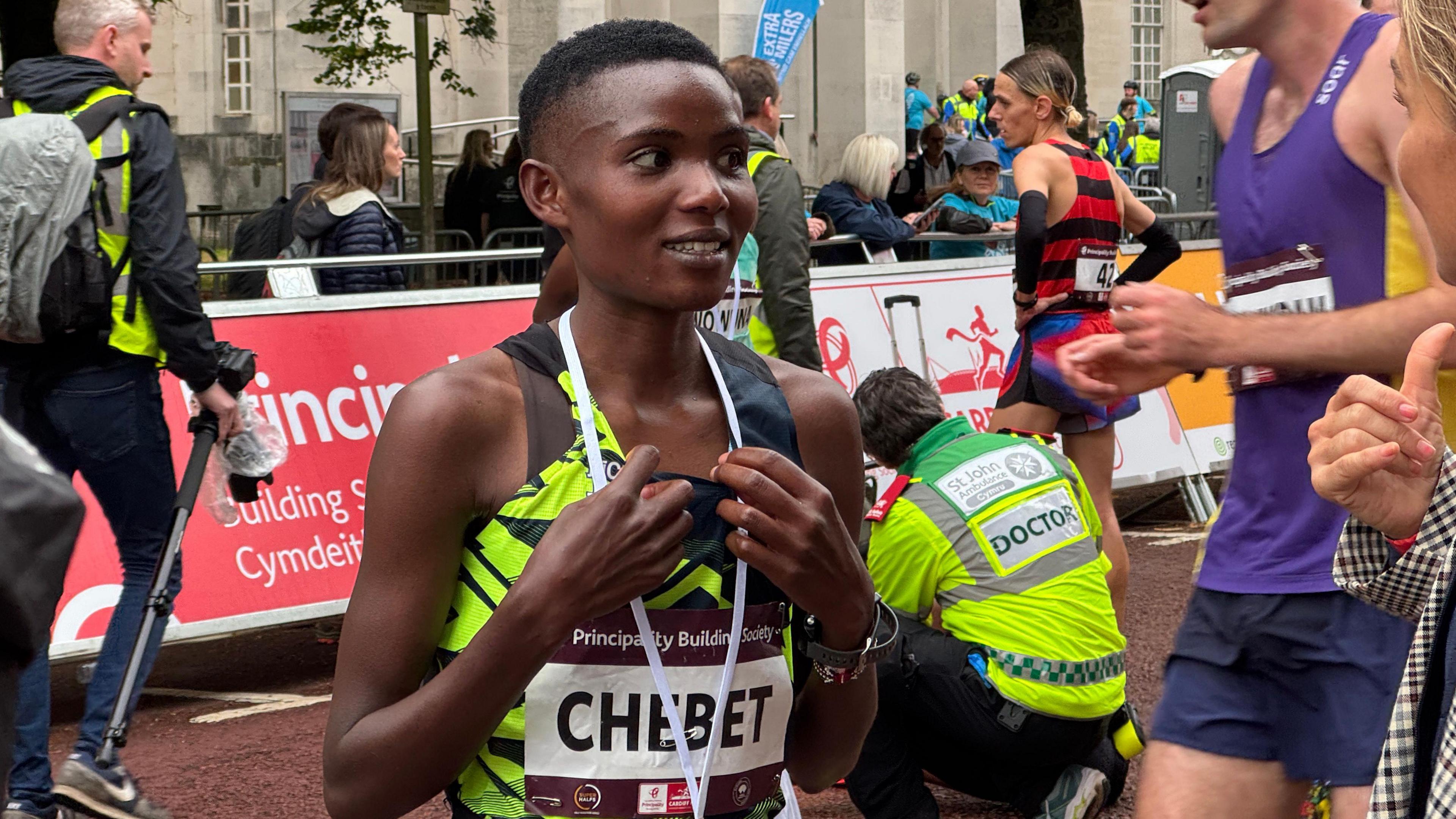 Miriam Chebet with her winner's medal around her neck on the finish line