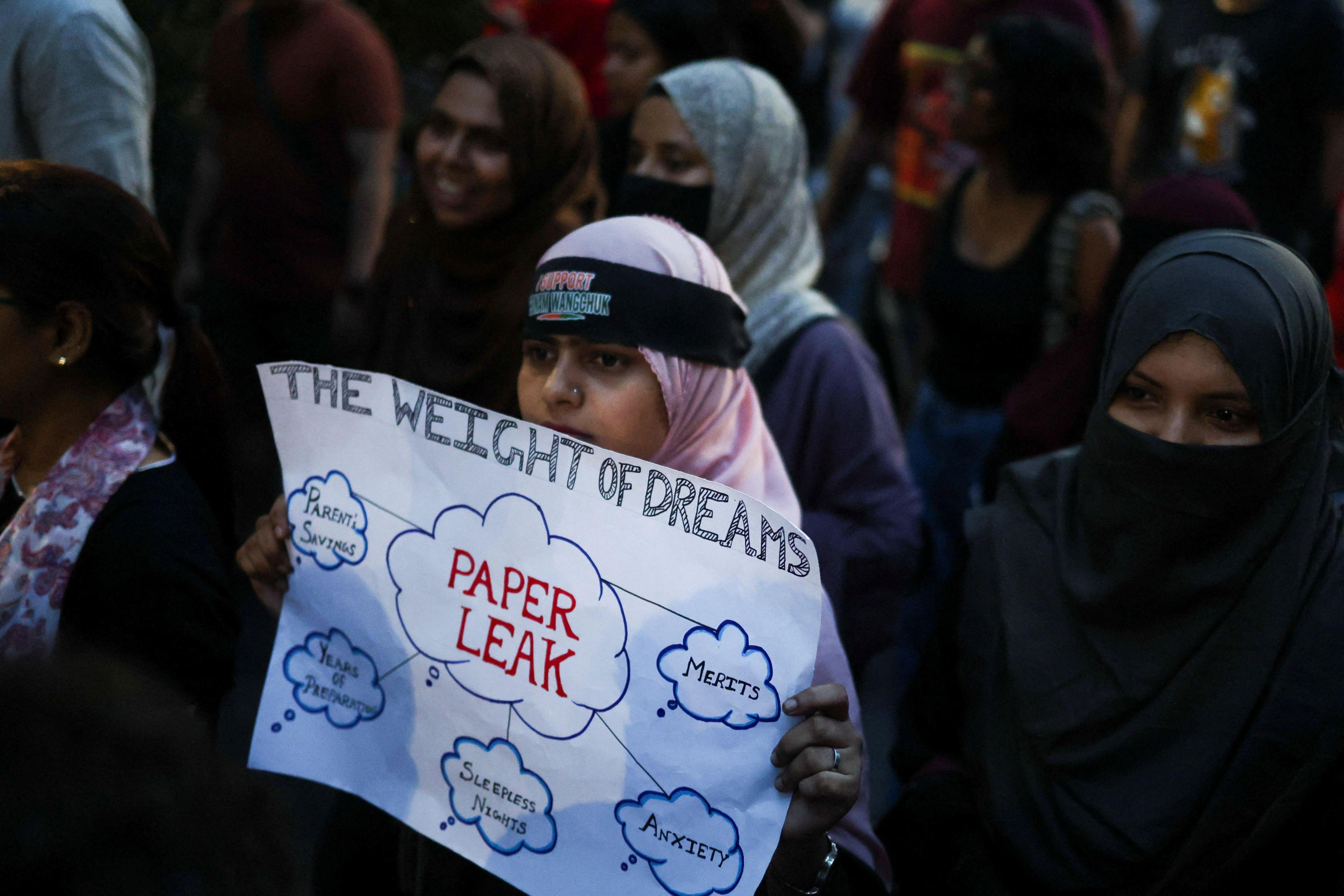 Women march in solidarity with India's Cockroach Janta Party and their march towards the parliament in New Delhi on the opening day of its monsoon session, demanding the resignation of Education Minister Dharmendra Pradhan over exam paper leaks, in Kolkata.