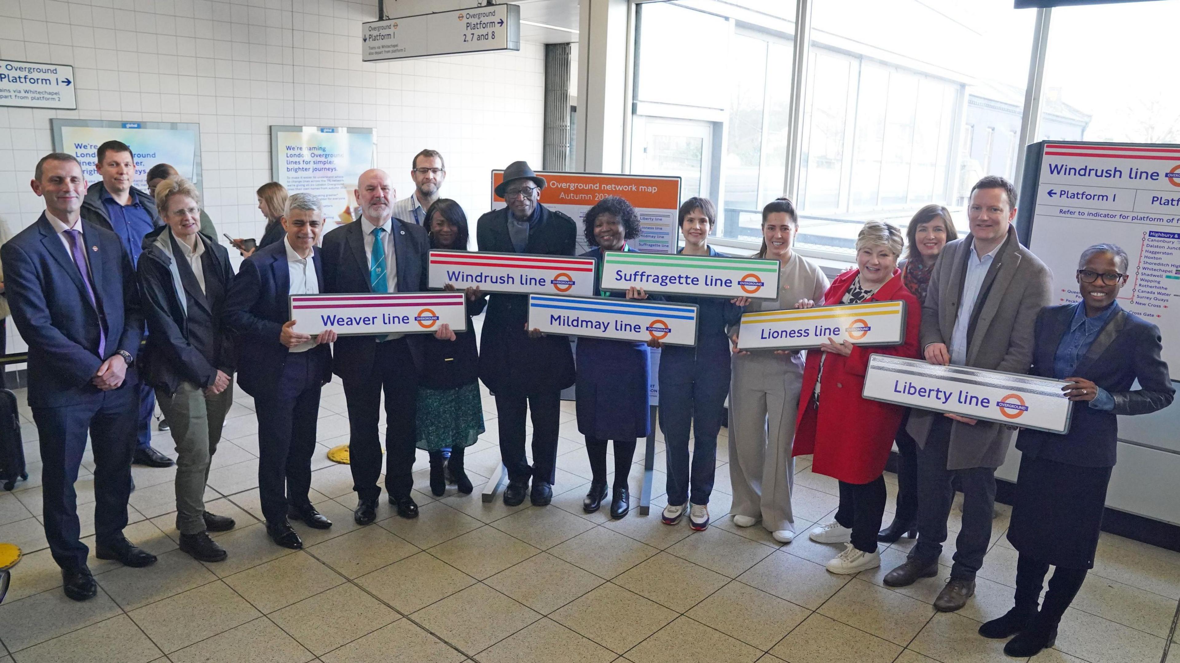 Mayor of London Sadiq Khan (third left) with representatives during a visit to Highbury and Islington underground station, north London. All hold the new names of the Overground signs.