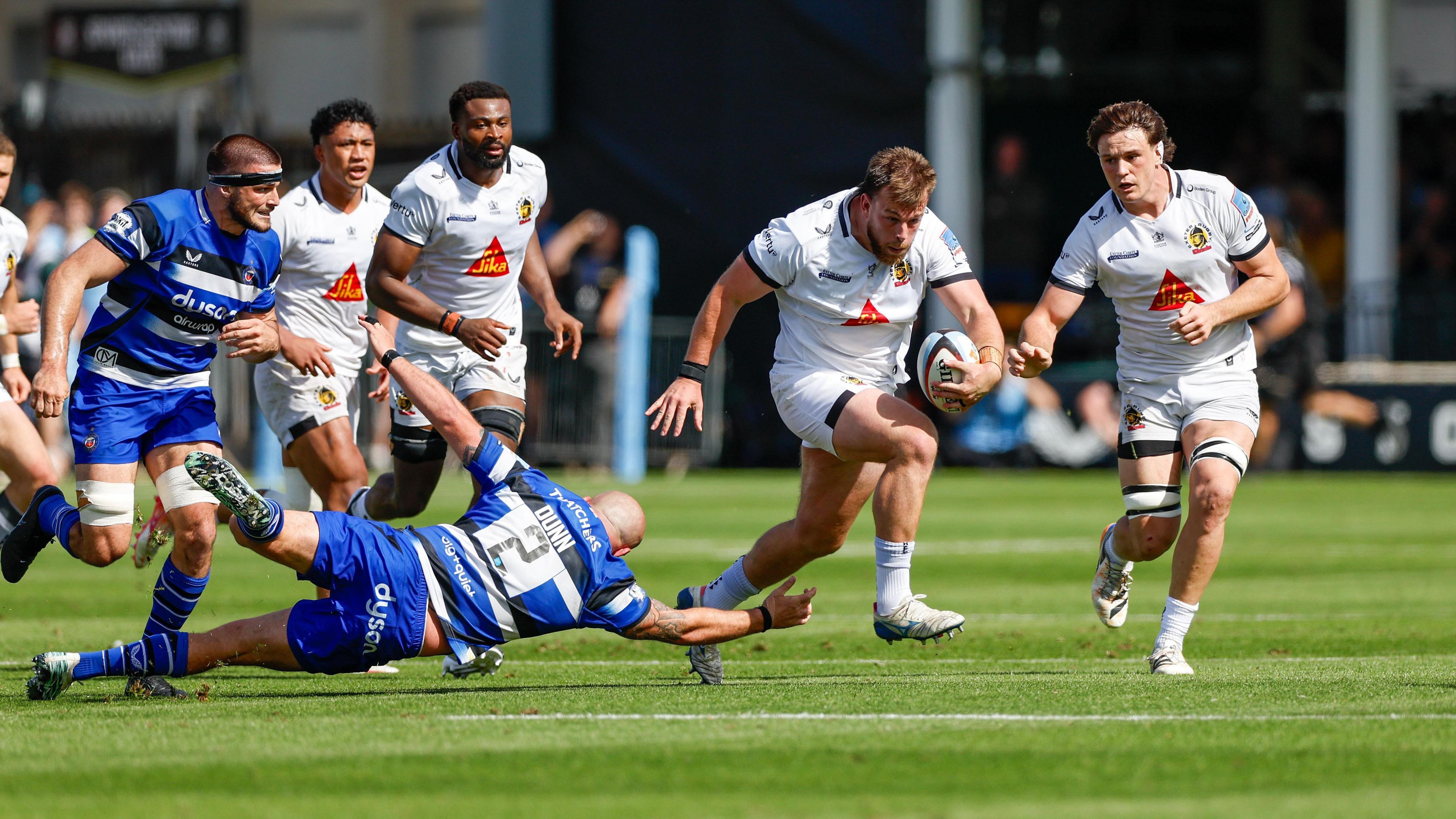 Ethan Burger (right) skips past Tom Dunn's tackle on the floor 
