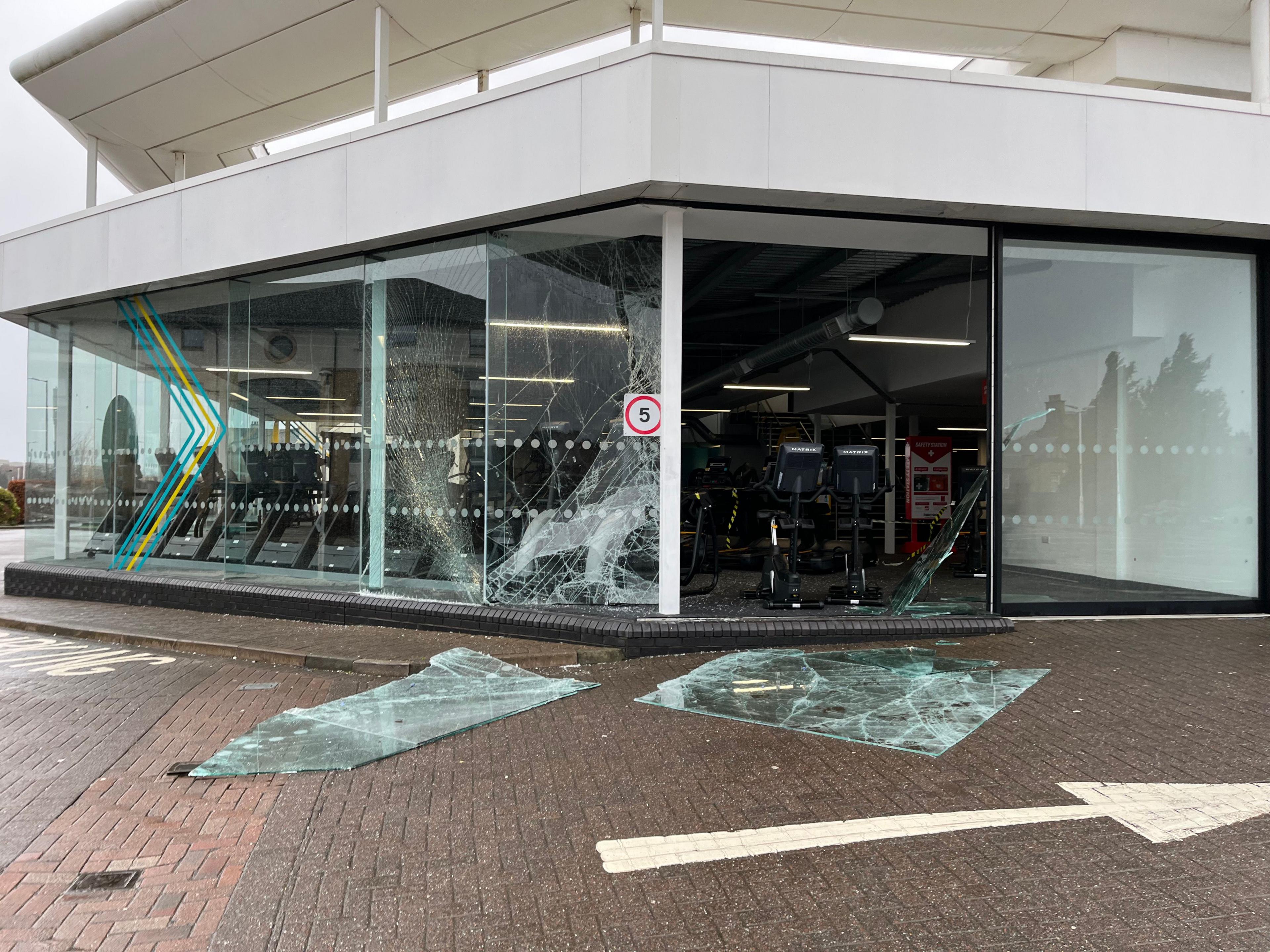 Ground floor gym with floor to ceiling walls of glass - two of the panes have been badly damaged by the wind